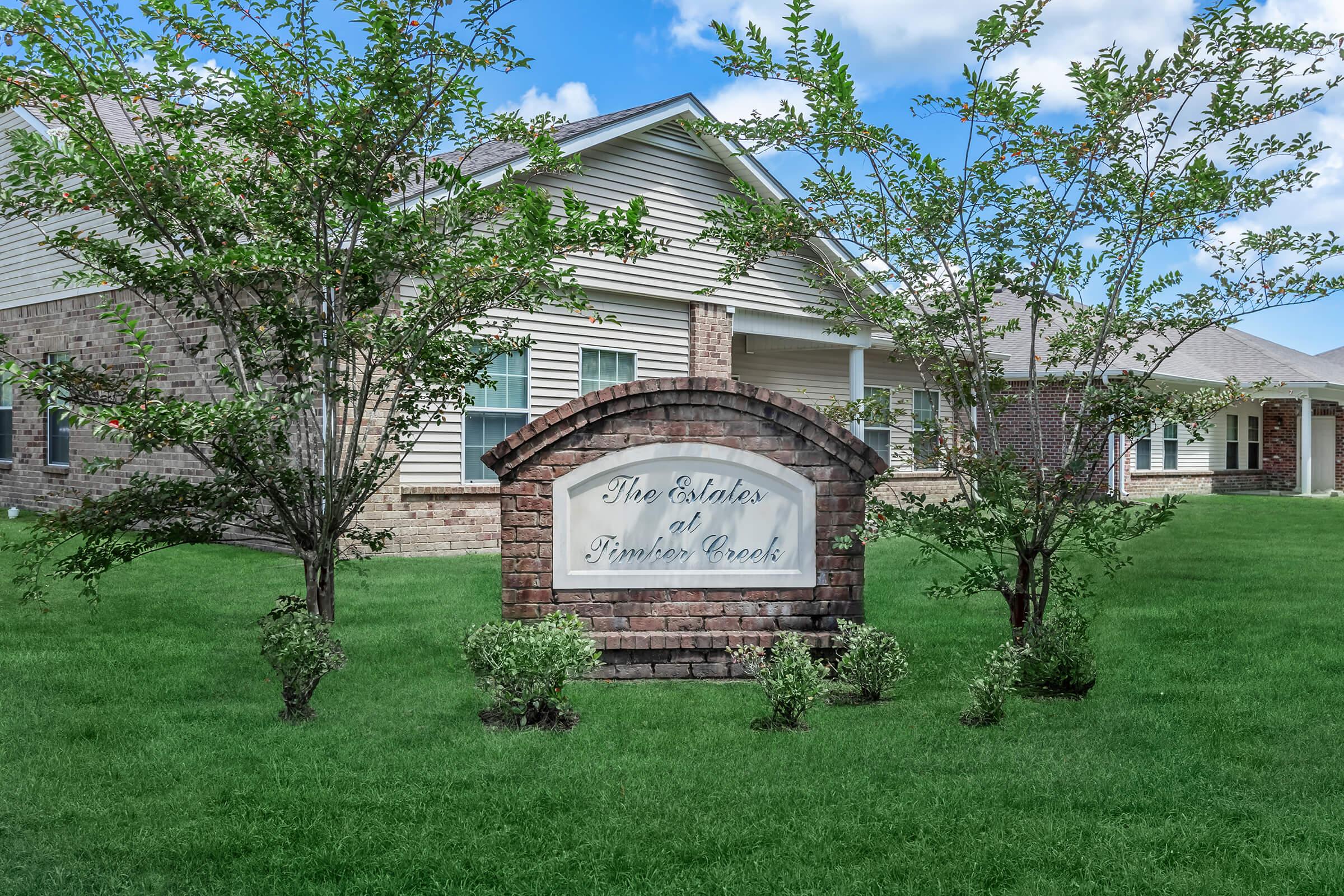 a clock on the front yard of a house
