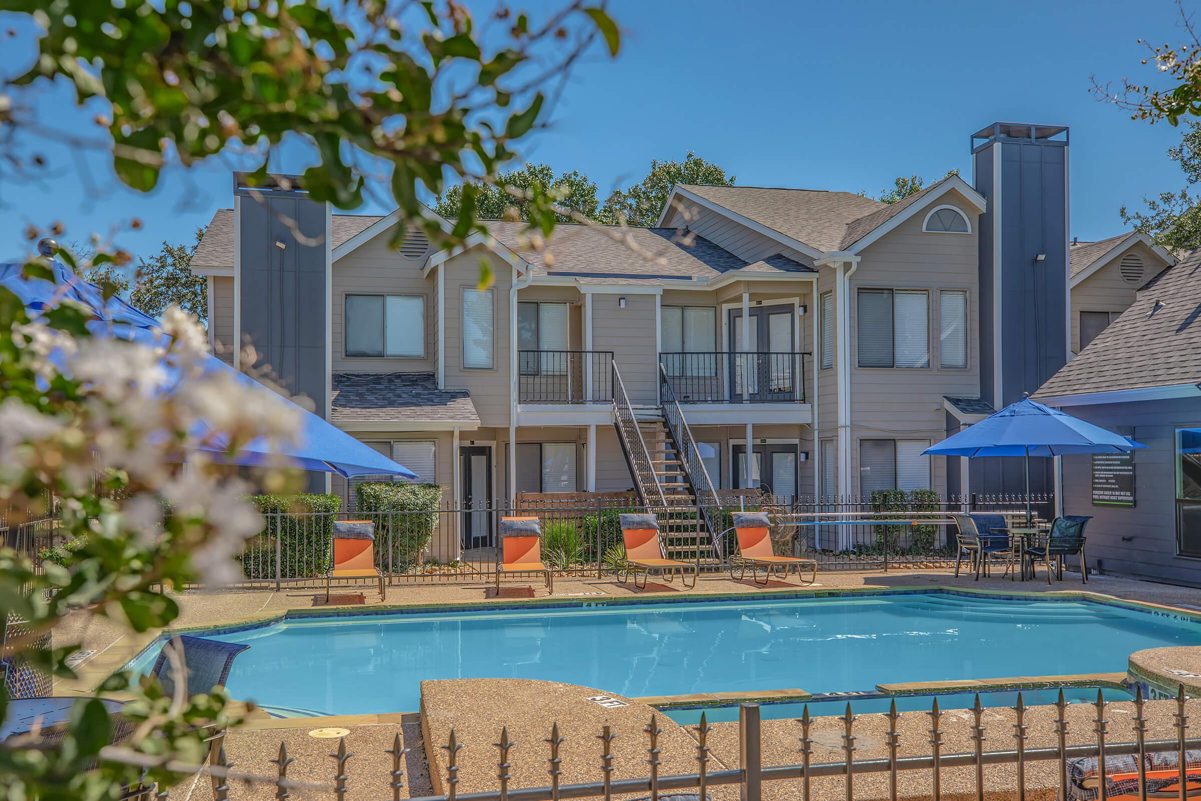 a house with a pool in front of a building