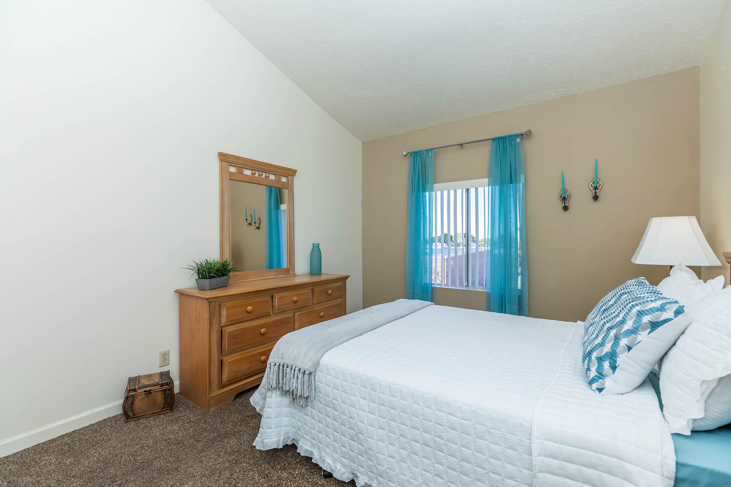 bedroom with blue window curtains