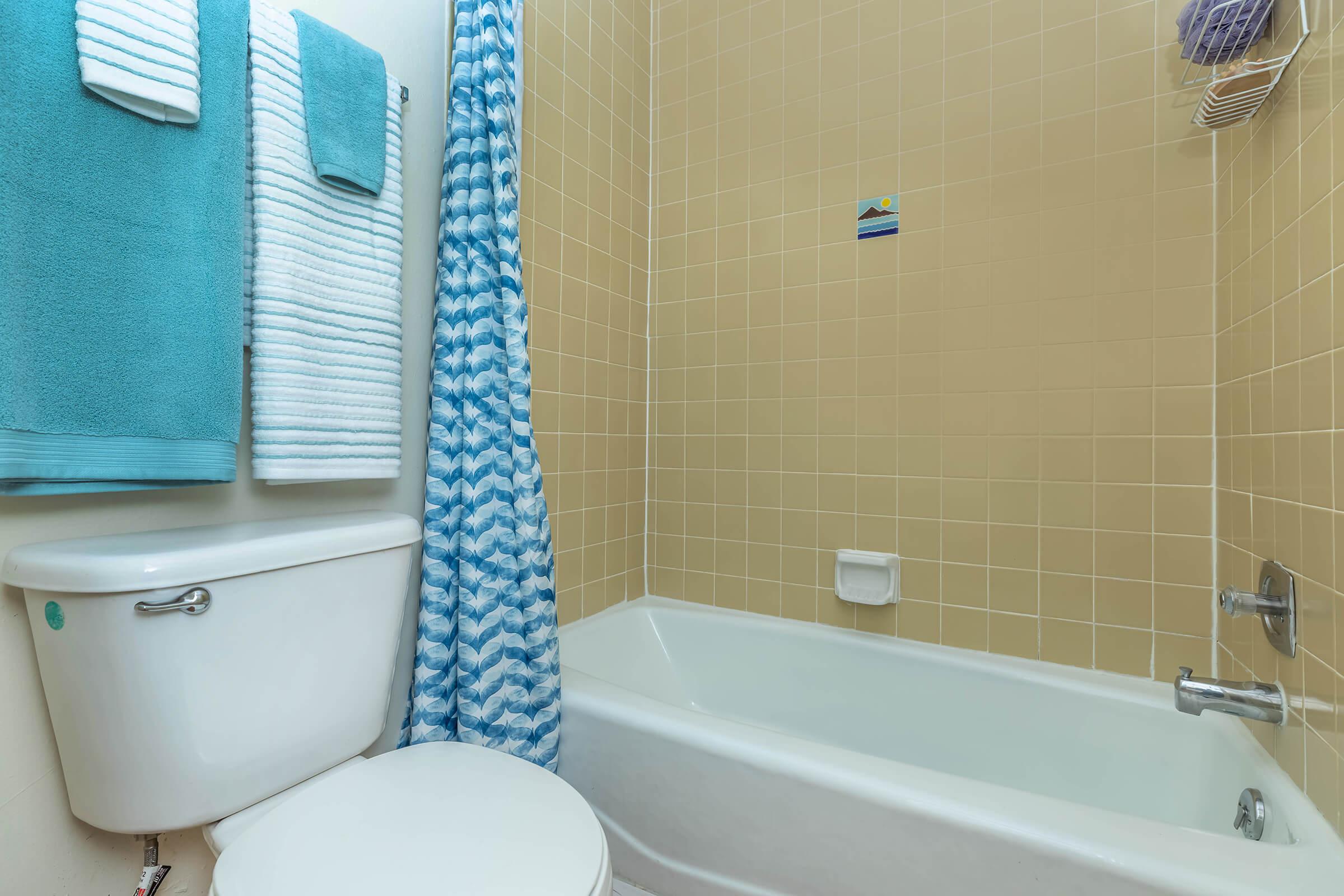 bathroom with yellow shower tiles