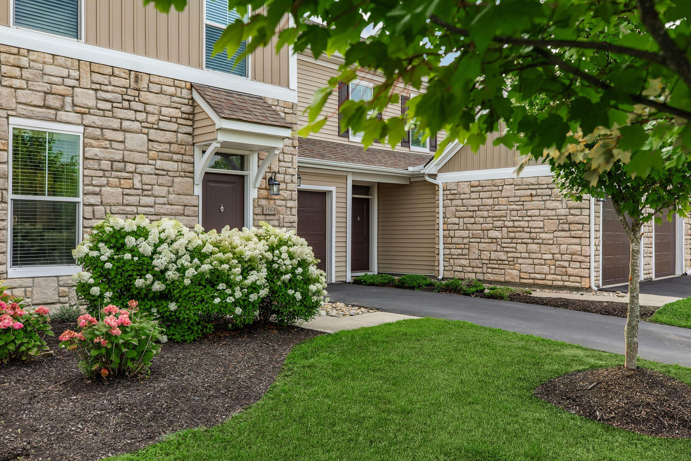 a close up of a flower garden in front of a building