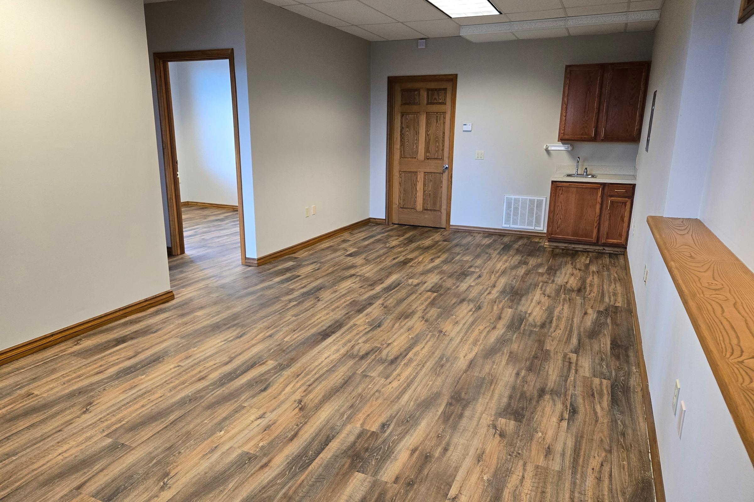 a bedroom with a wooden floor