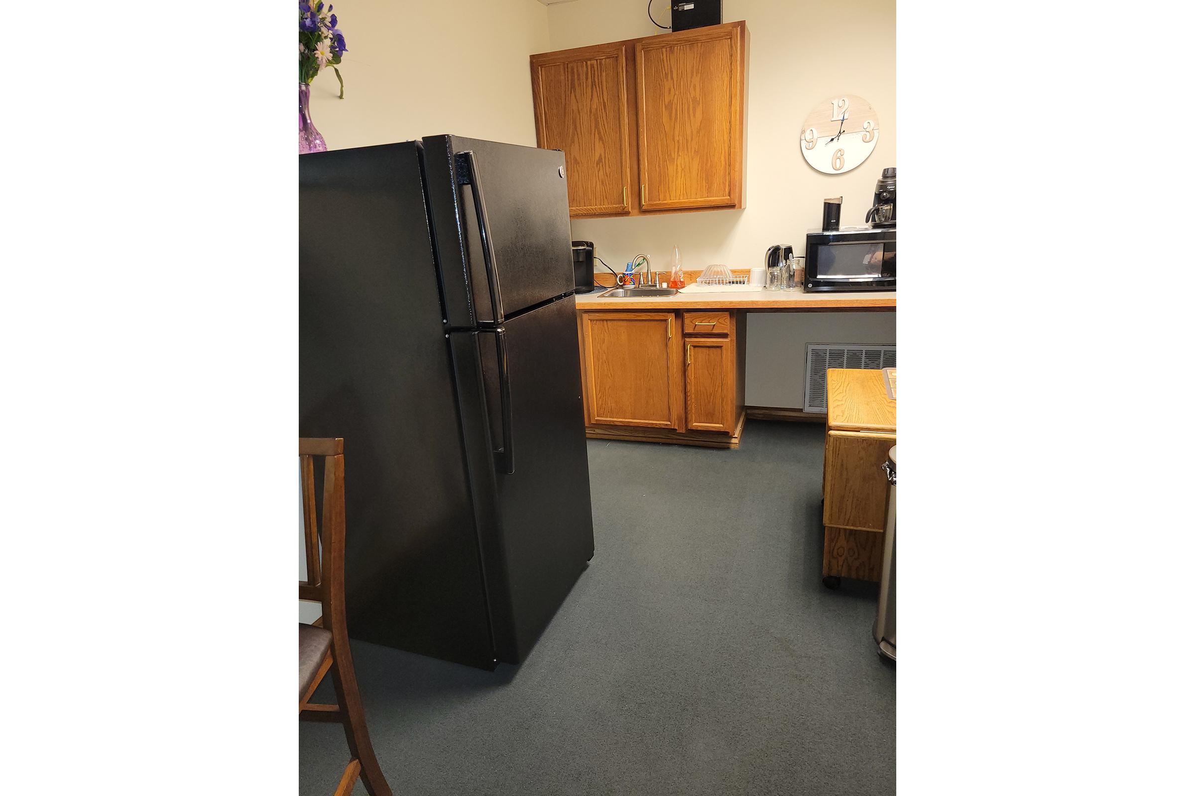 a chair sitting in front of a refrigerator