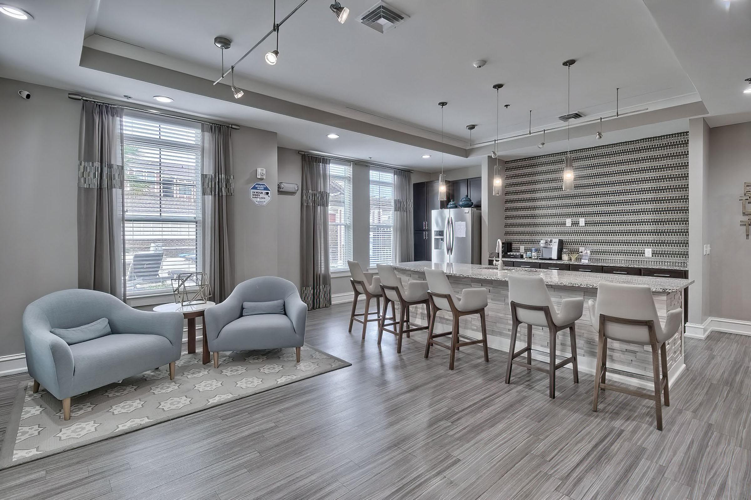 a living room filled with furniture and a large window