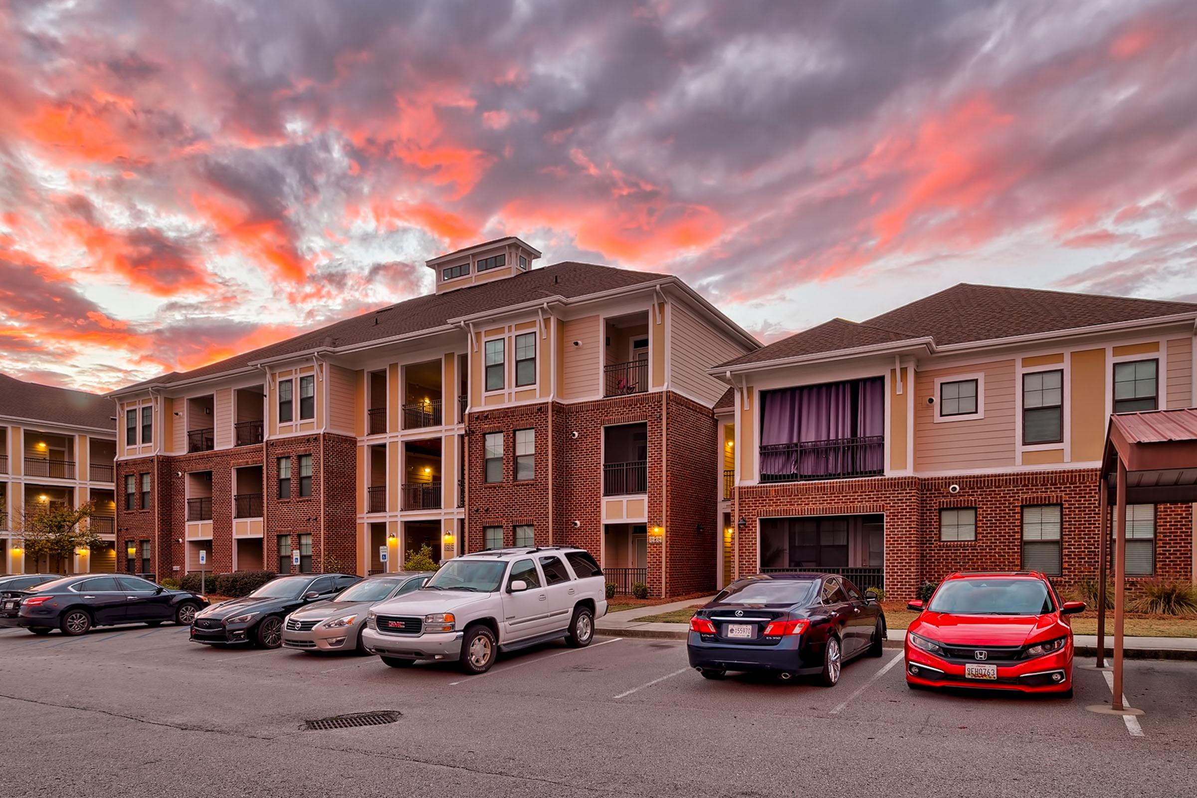 a car parked in a parking lot in front of a building