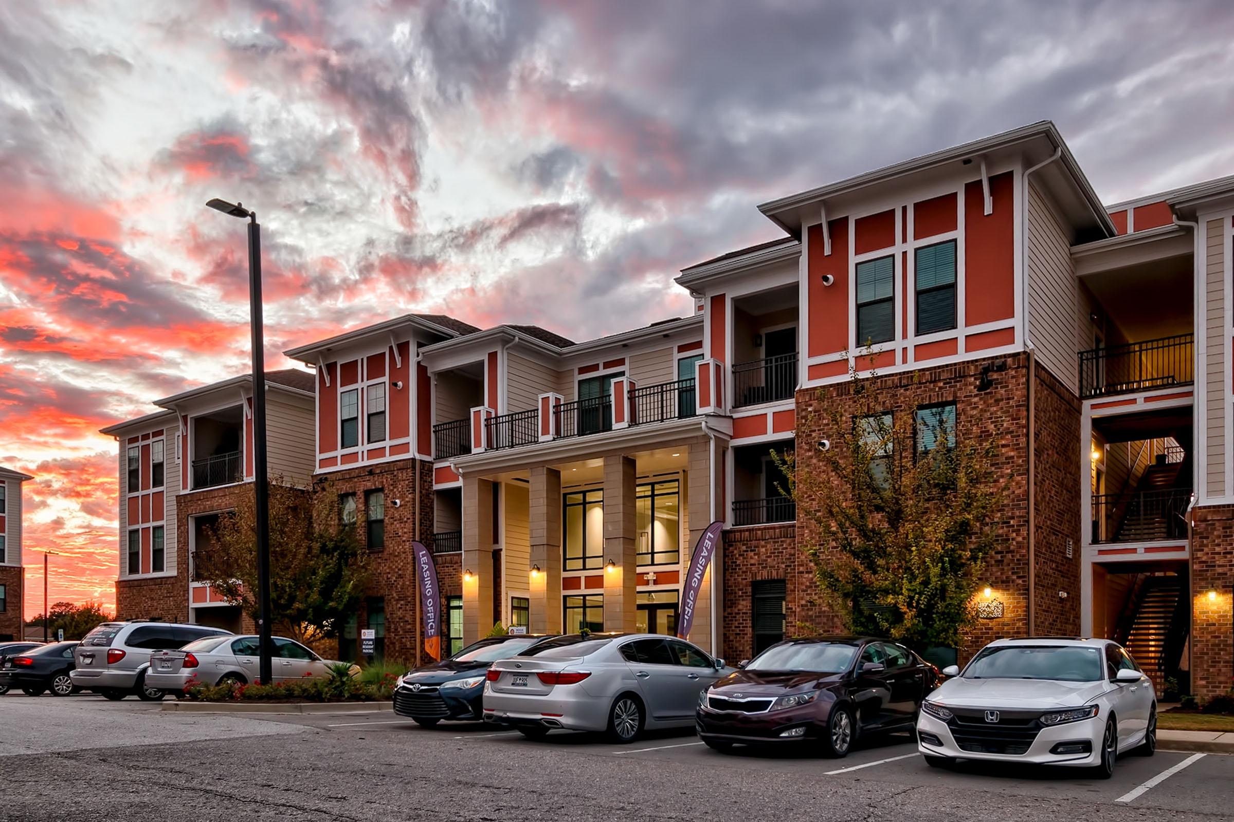 a car parked in a parking lot in front of a building