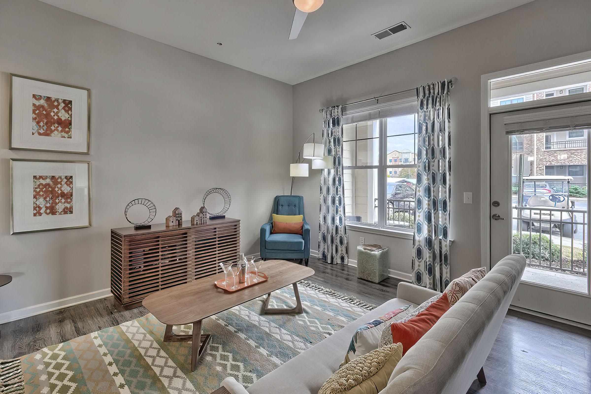 a living room filled with furniture and a large window