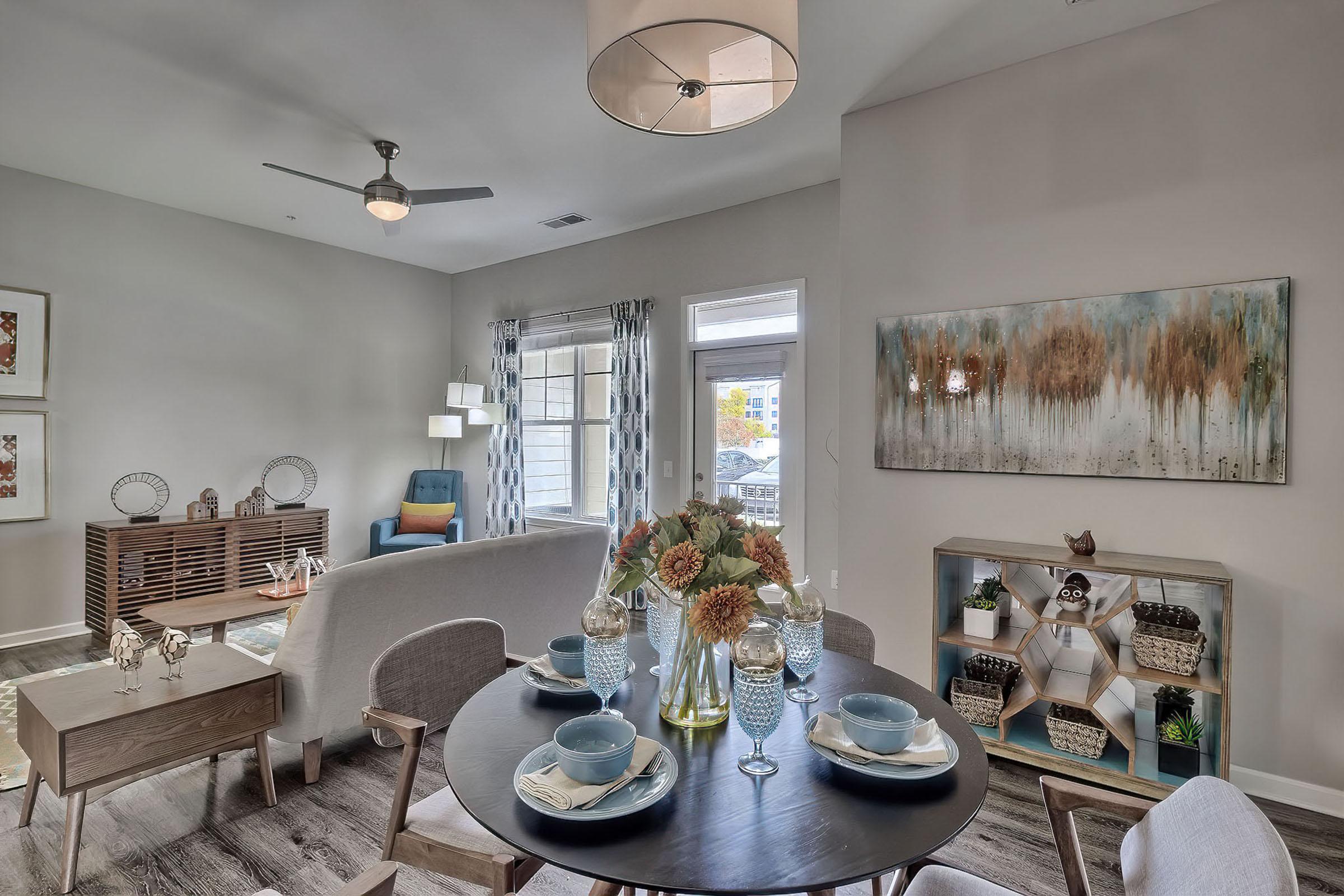 a room filled with furniture and vase of flowers on a table