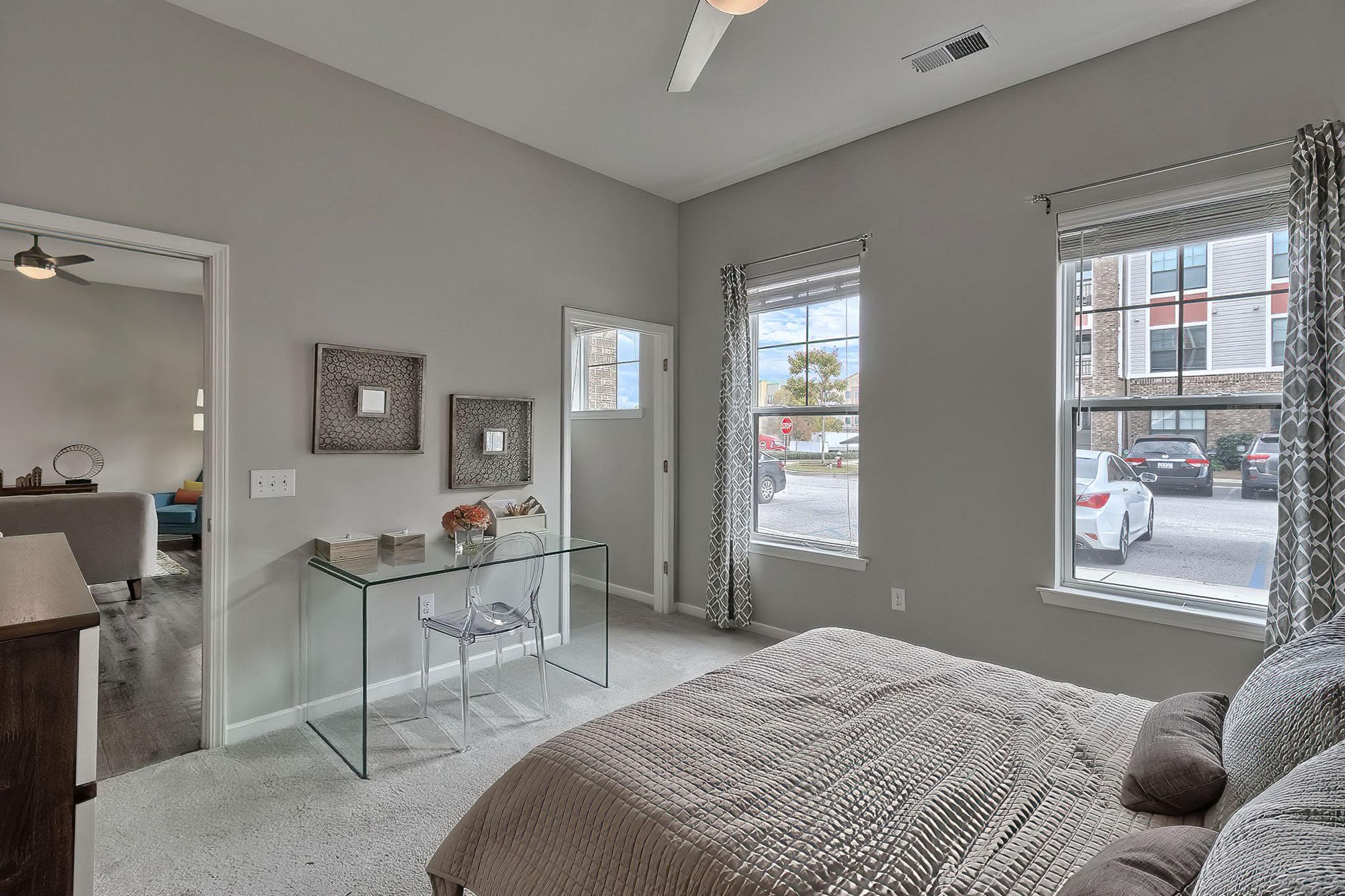 a bedroom with a bed and a chair in a room