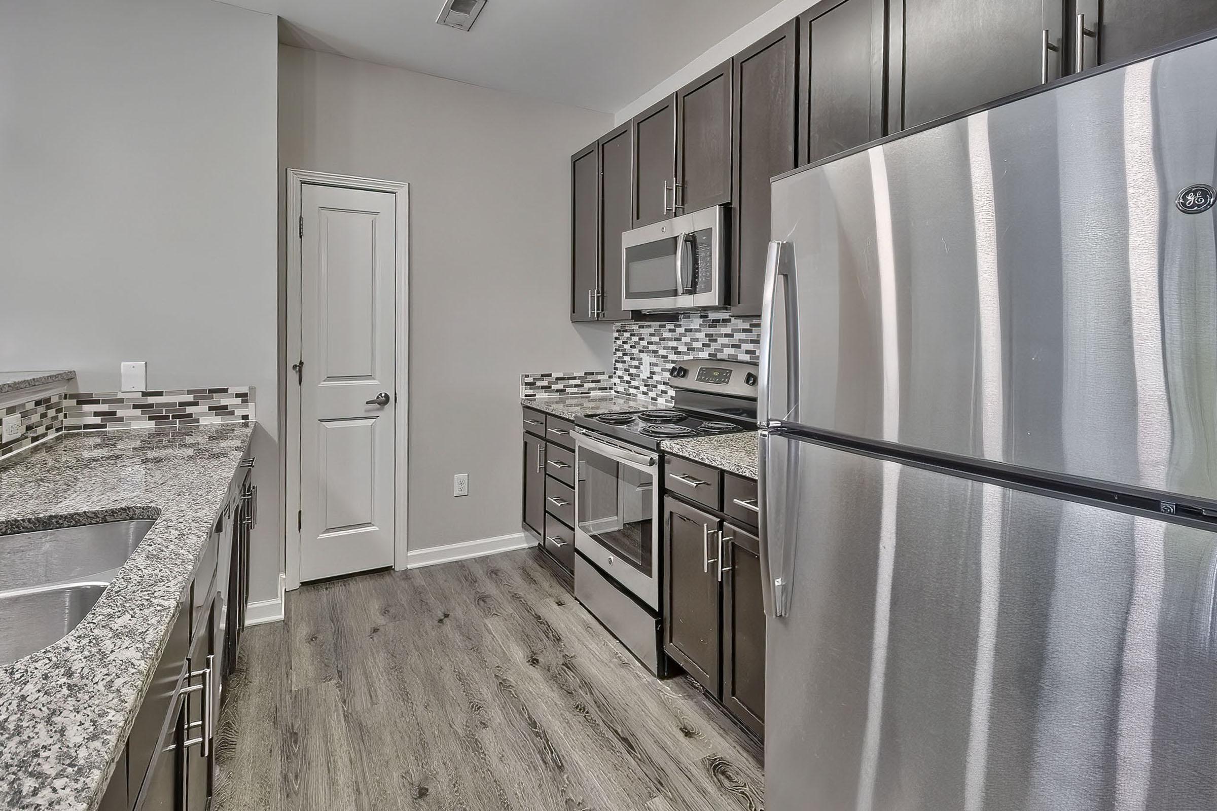 a kitchen with a sink and a refrigerator