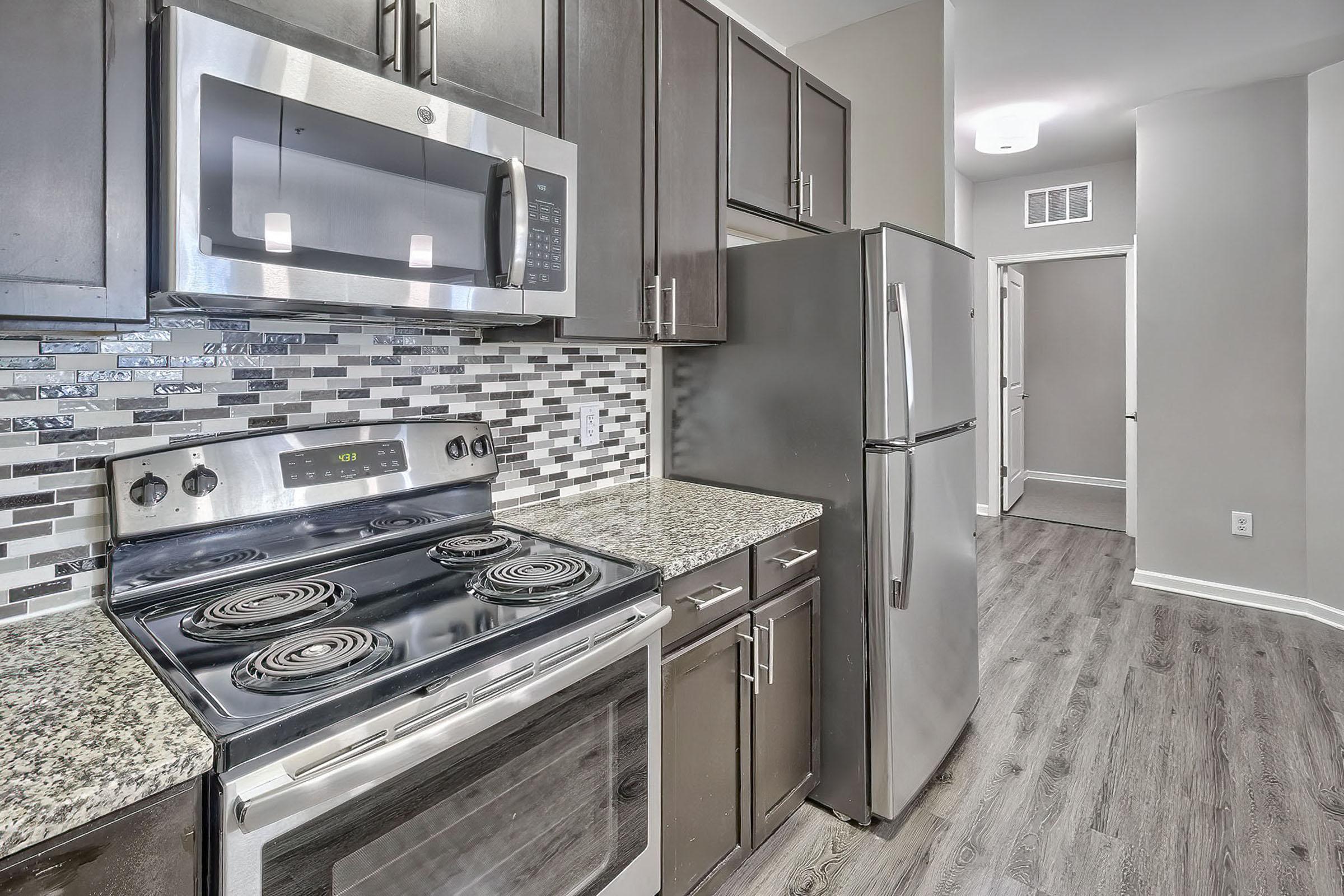 a stove top oven sitting inside of a kitchen