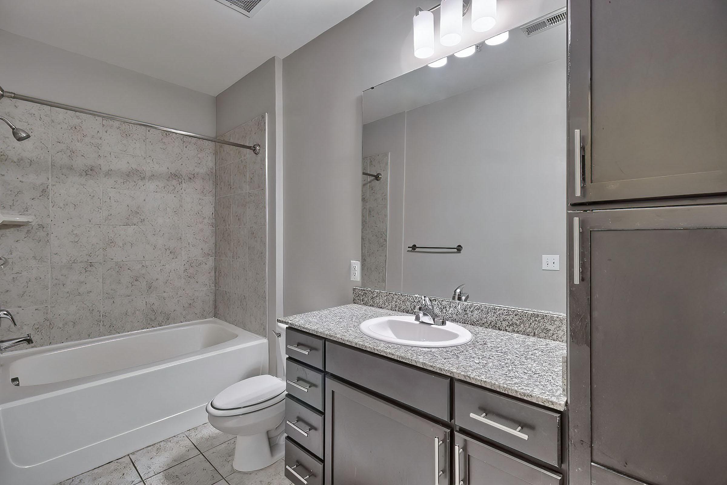 a kitchen with a sink and a mirror