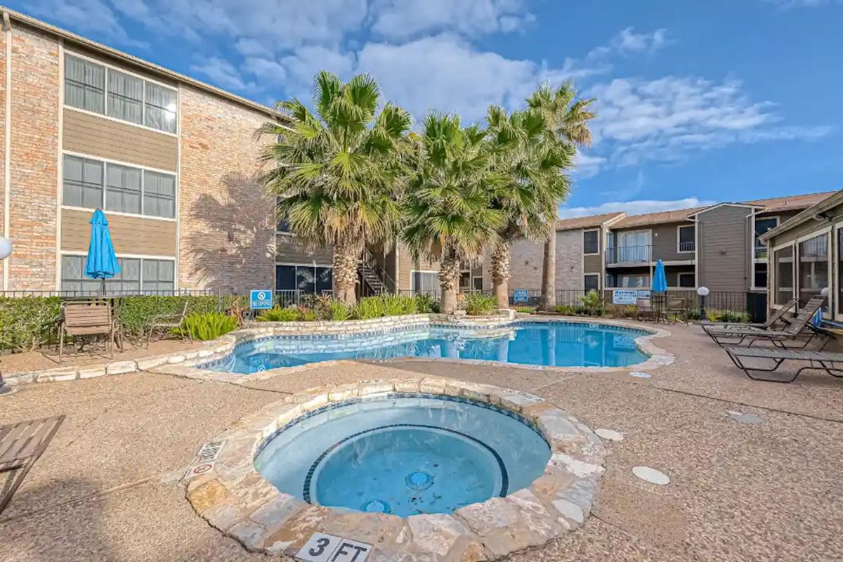 a pool in front of a brick building