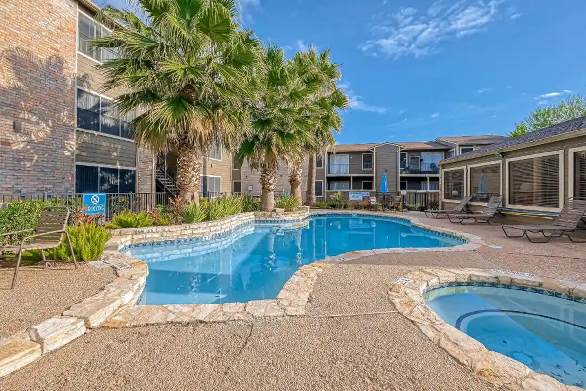 a house with a pool in front of a building