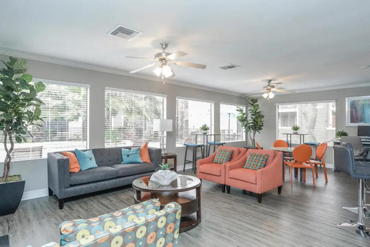 a living room filled with furniture and a large window