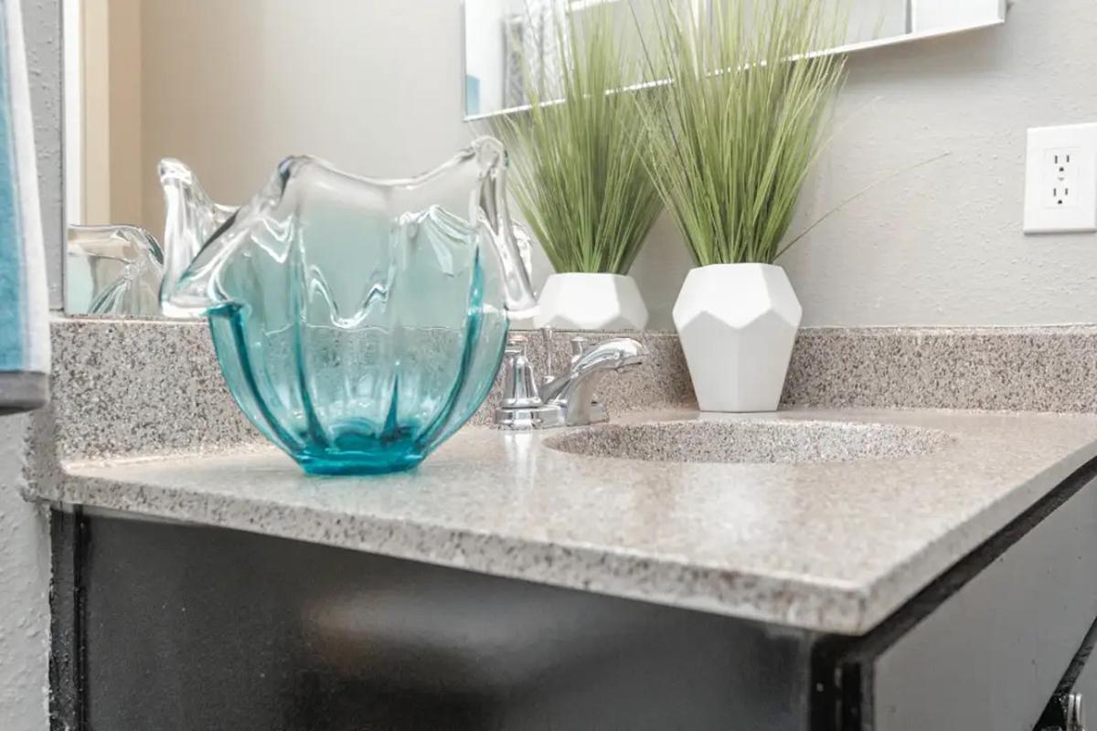 a vase filled with flowers sitting on a counter