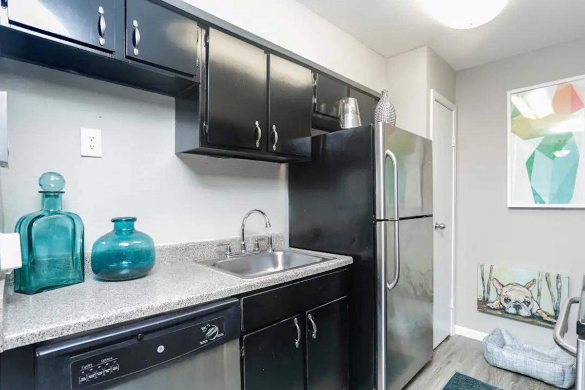 a kitchen with a sink and a mirror