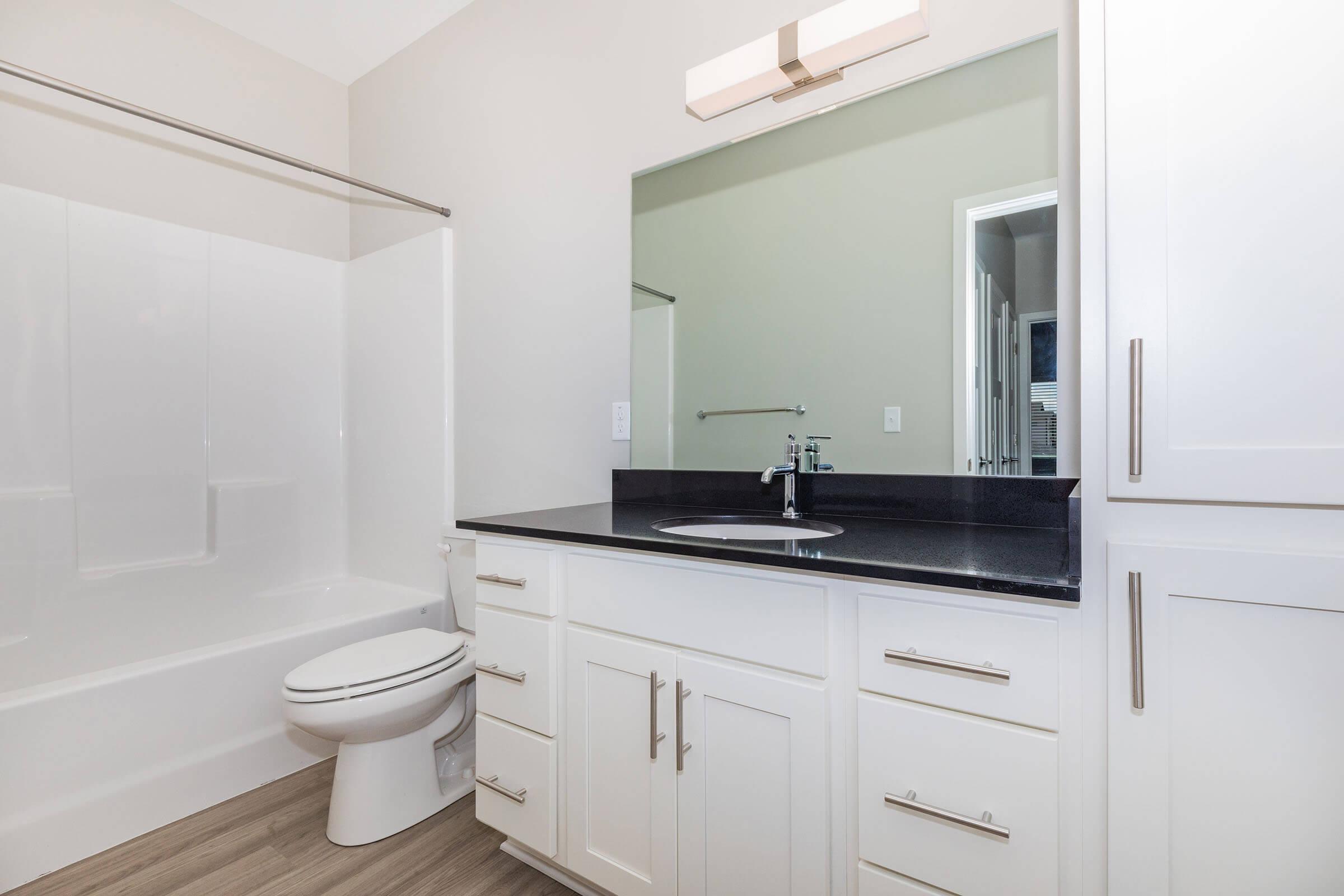 a kitchen with a sink and a mirror