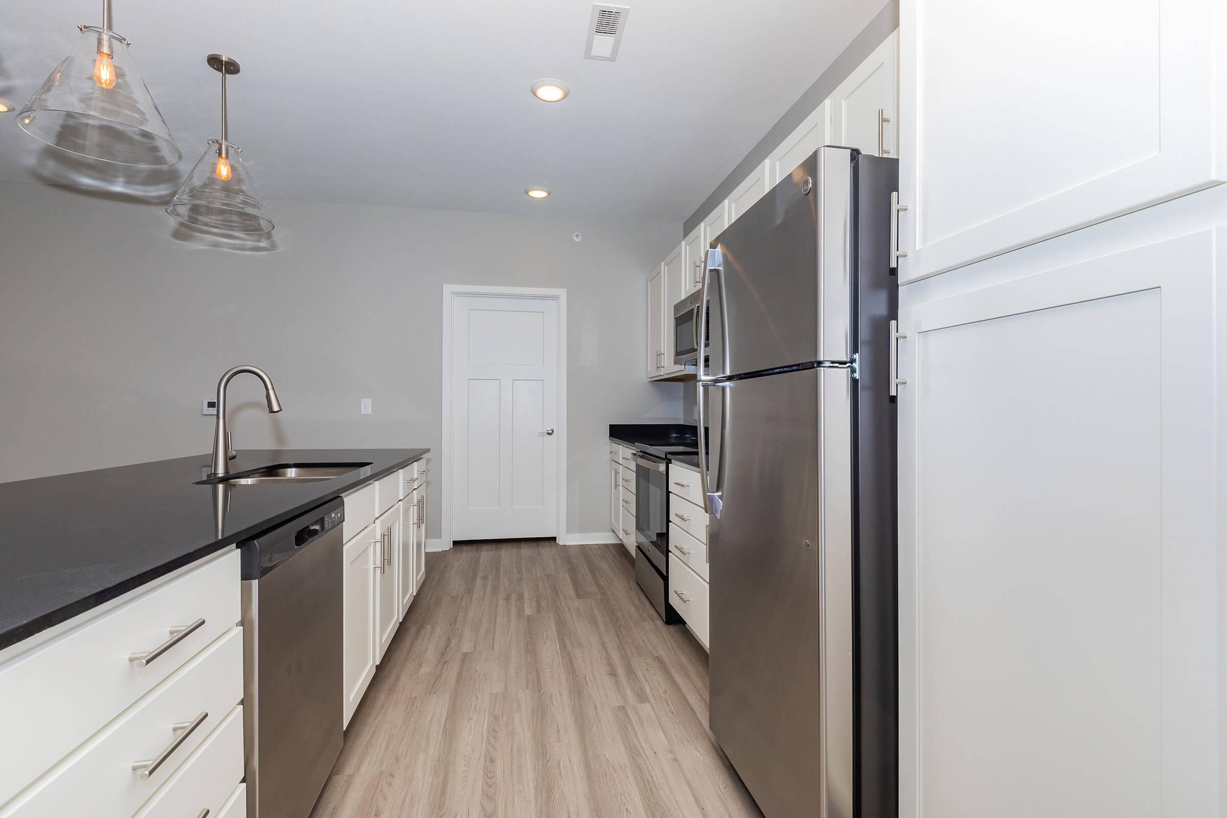 a kitchen with a sink and a refrigerator