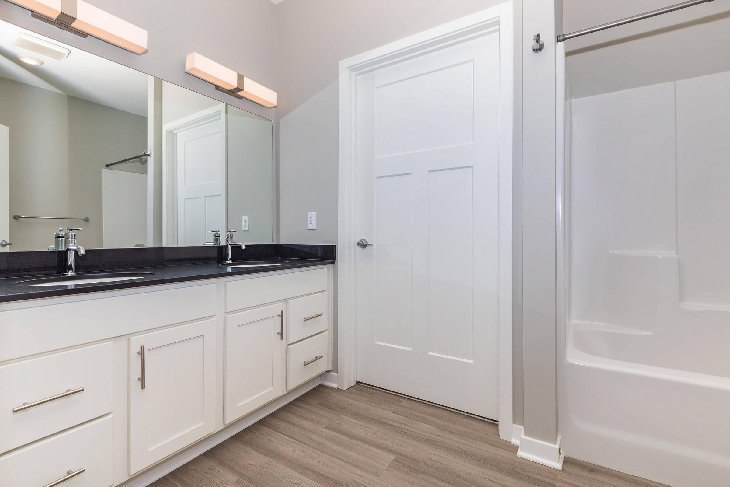 a kitchen with a sink and a mirror