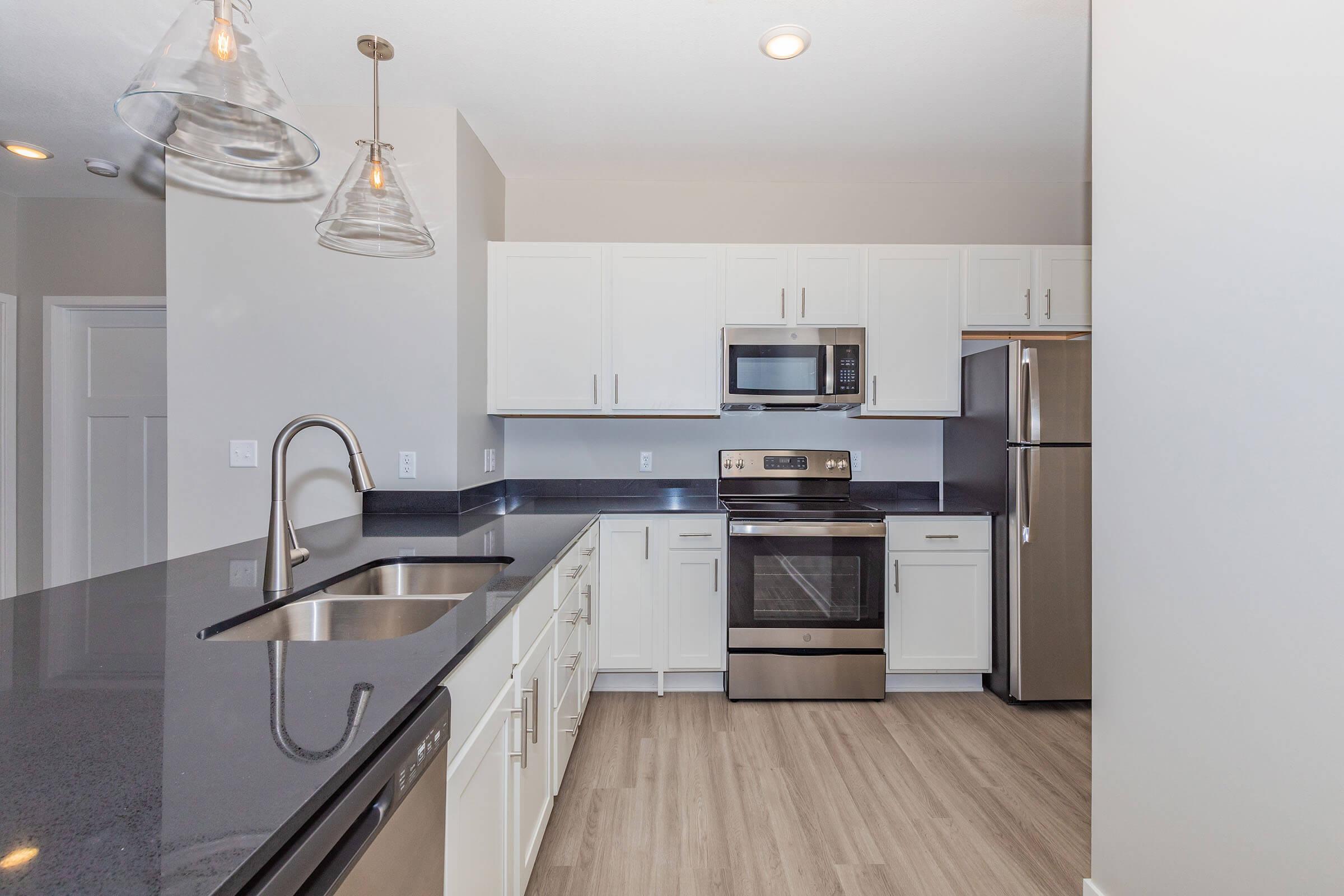 a kitchen with a stove and a refrigerator