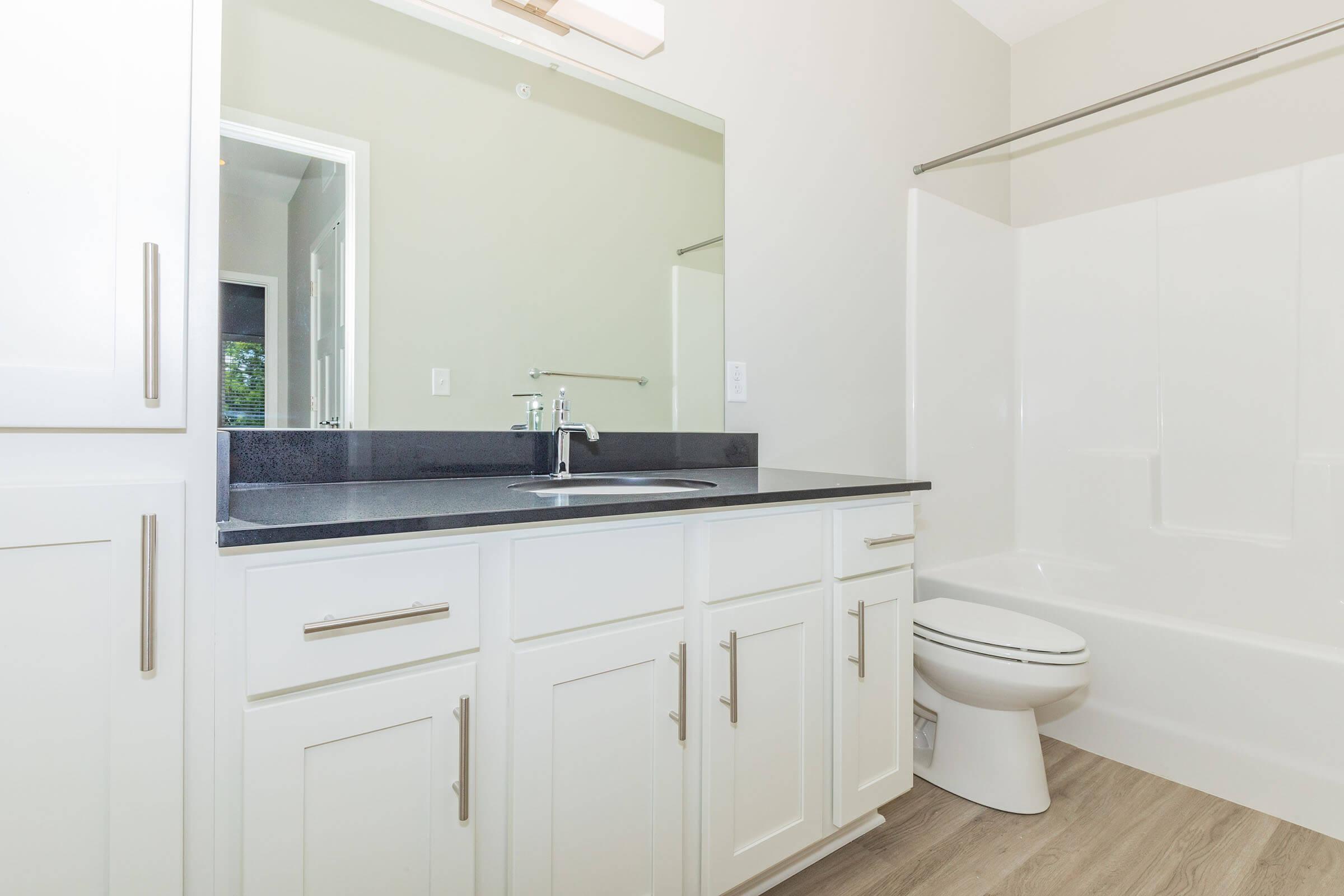 a kitchen with a sink and a mirror