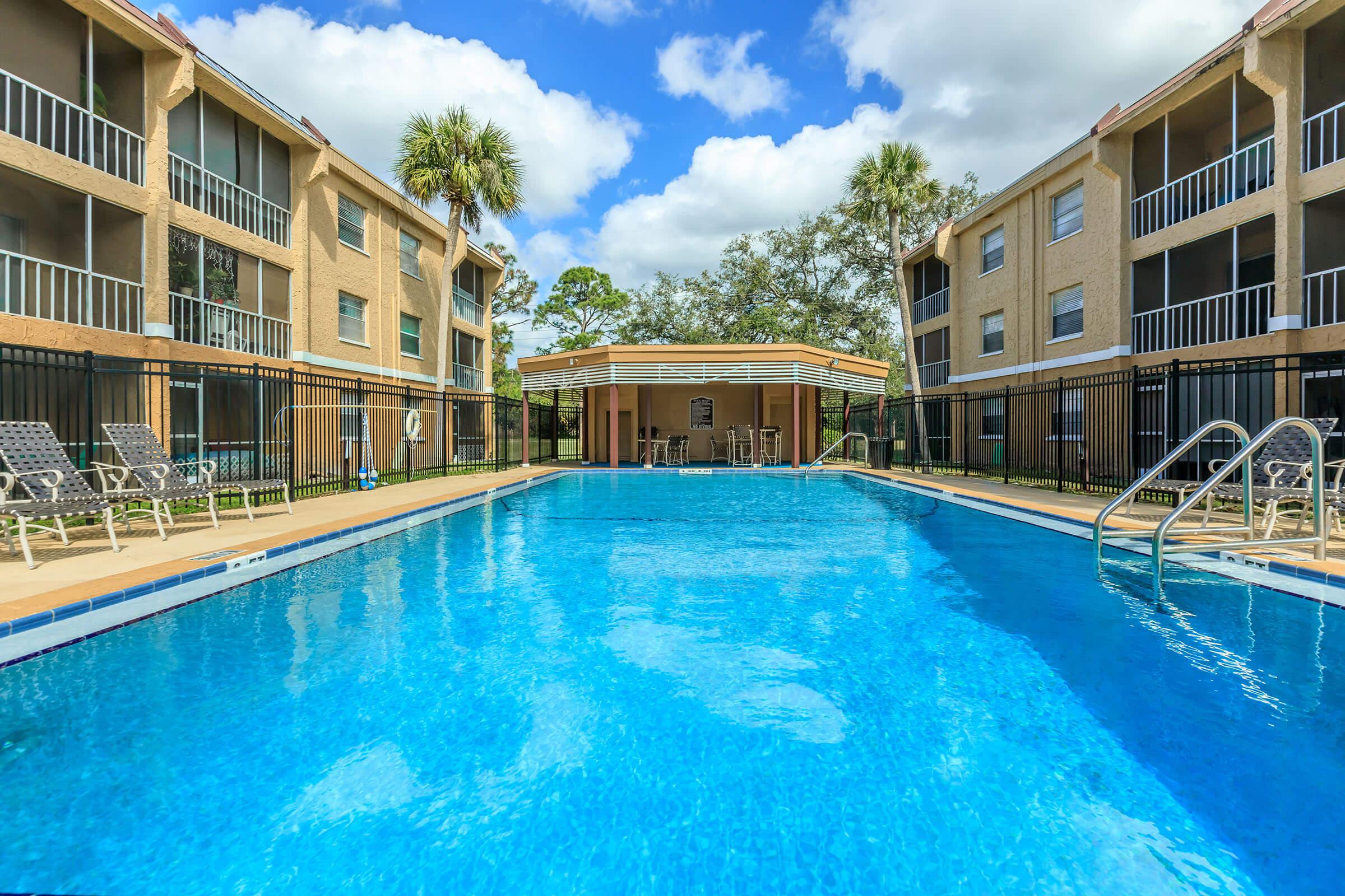 SOAK UP THE SUN BY THE SHIMMERING SWIMMING POOL