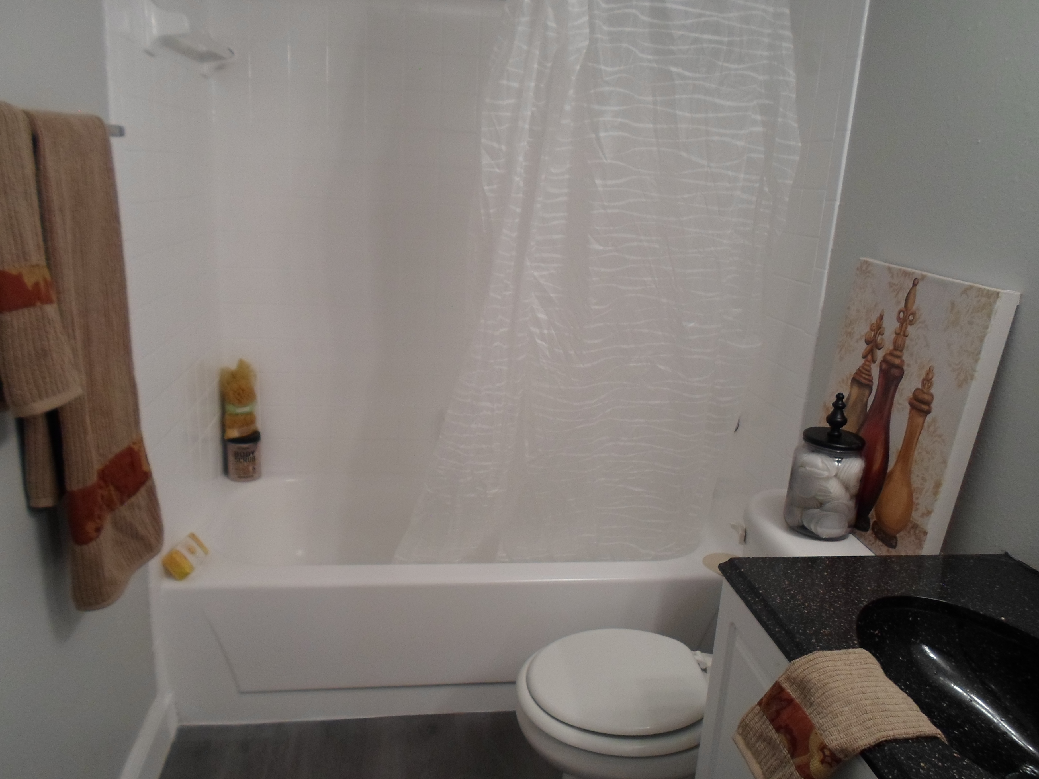 a shower curtain next to a tub