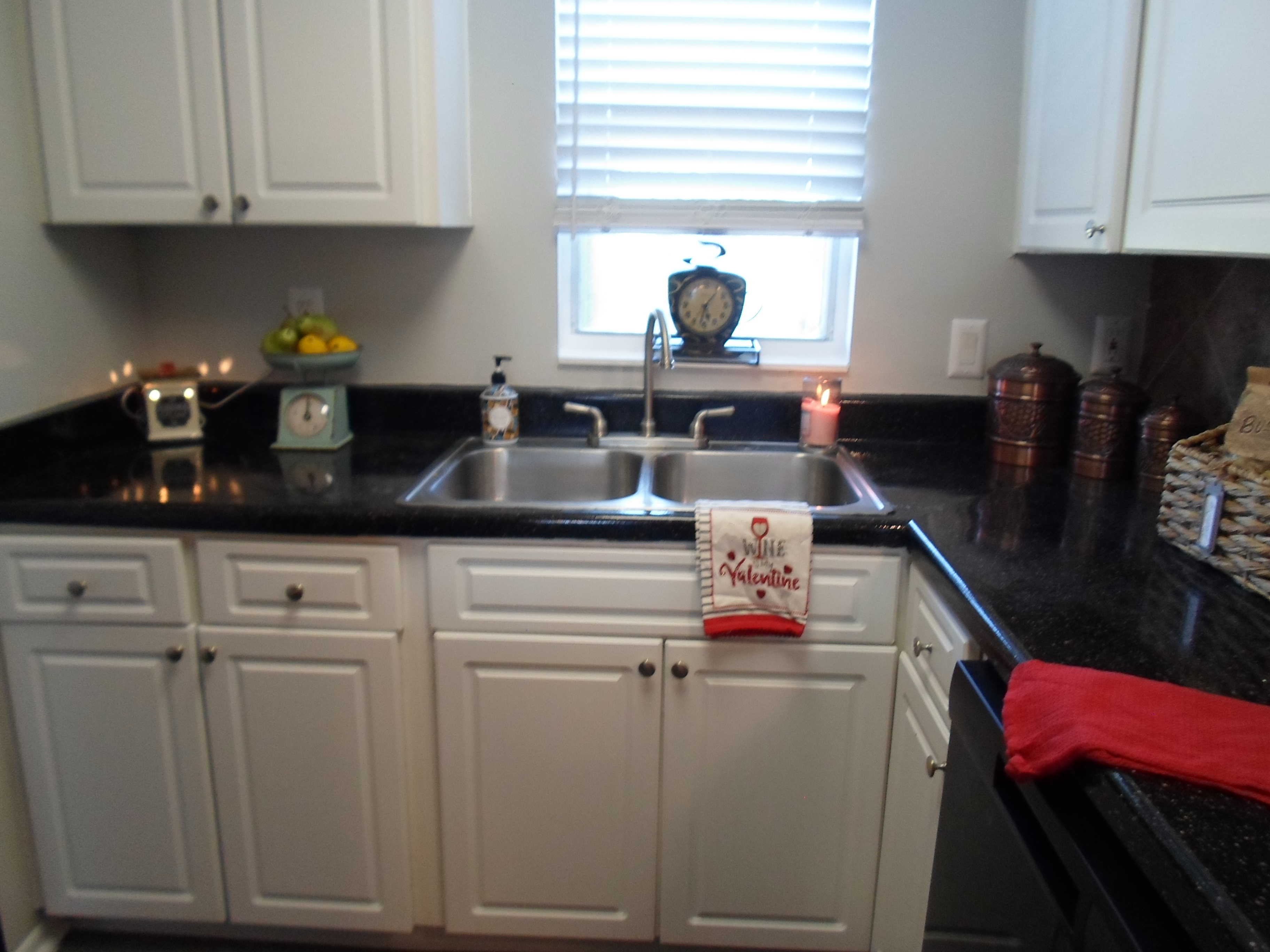 a kitchen with a stove a sink and a window