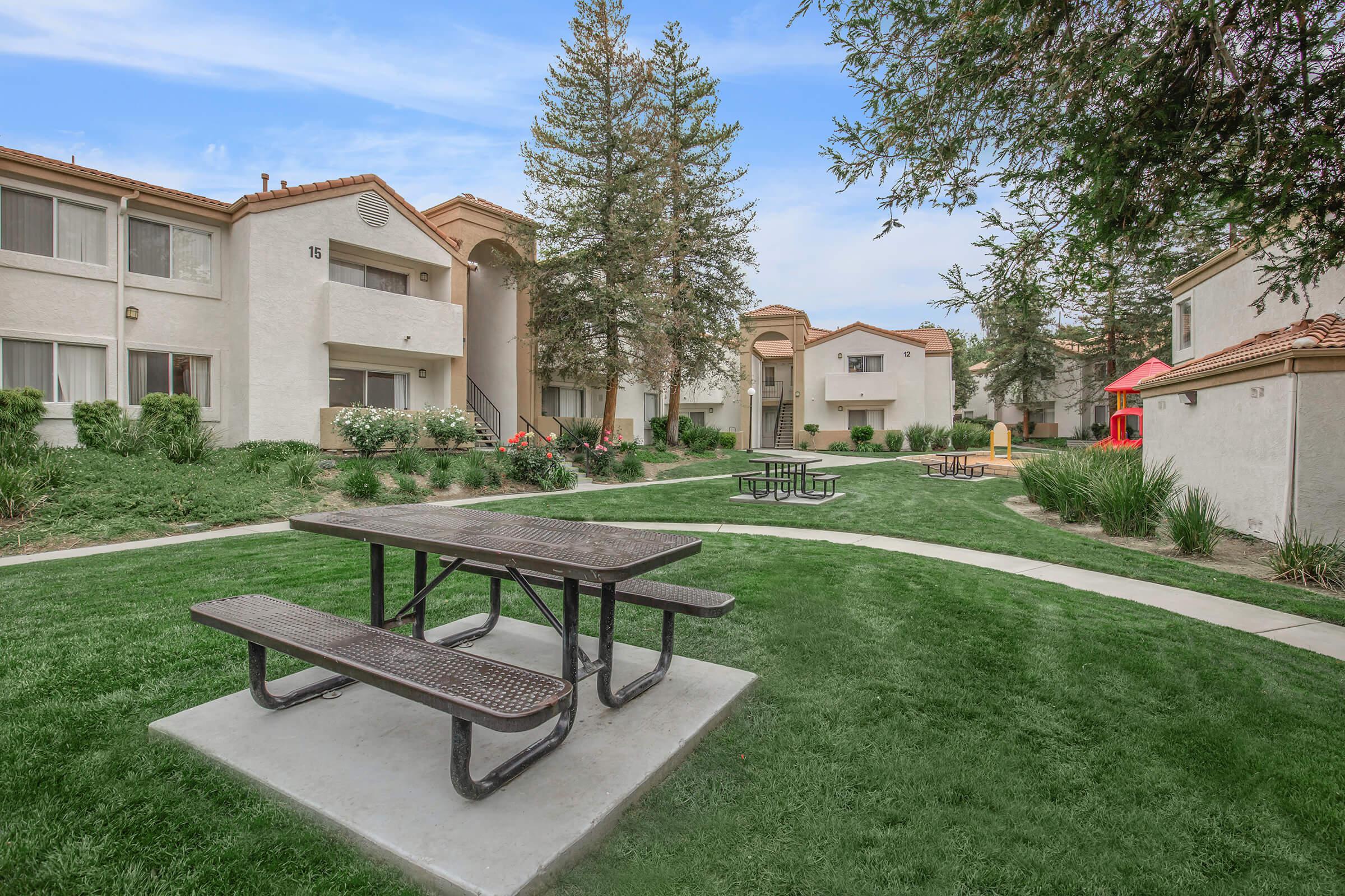 a wooden park bench sitting in front of a house