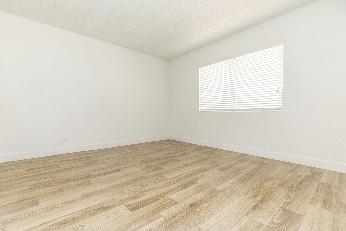 a bedroom with a wooden floor