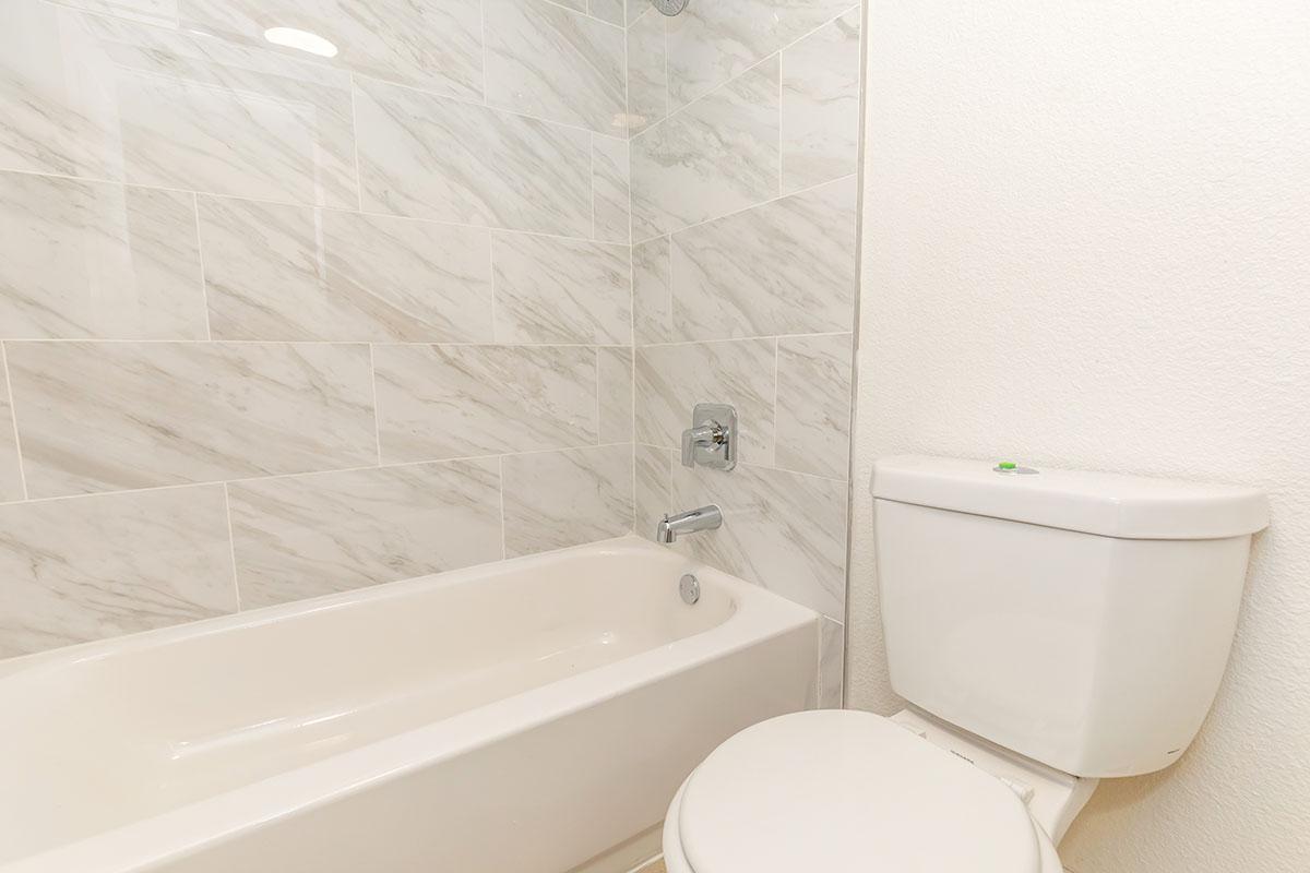 a white tub sitting next to a sink