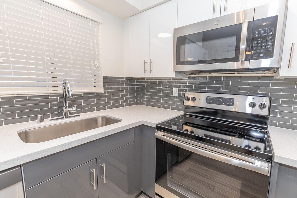 a stove top oven sitting inside of a kitchen