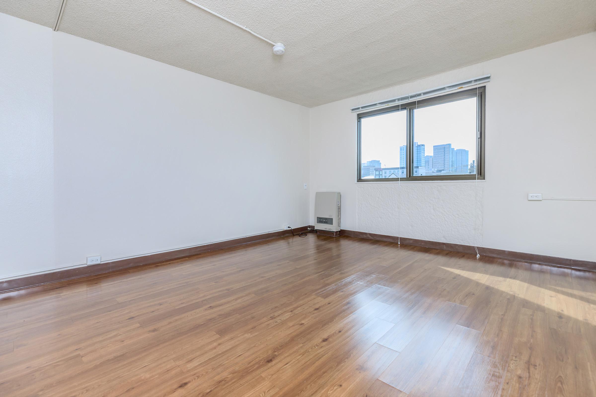 Unfurnished living room with wooden floors