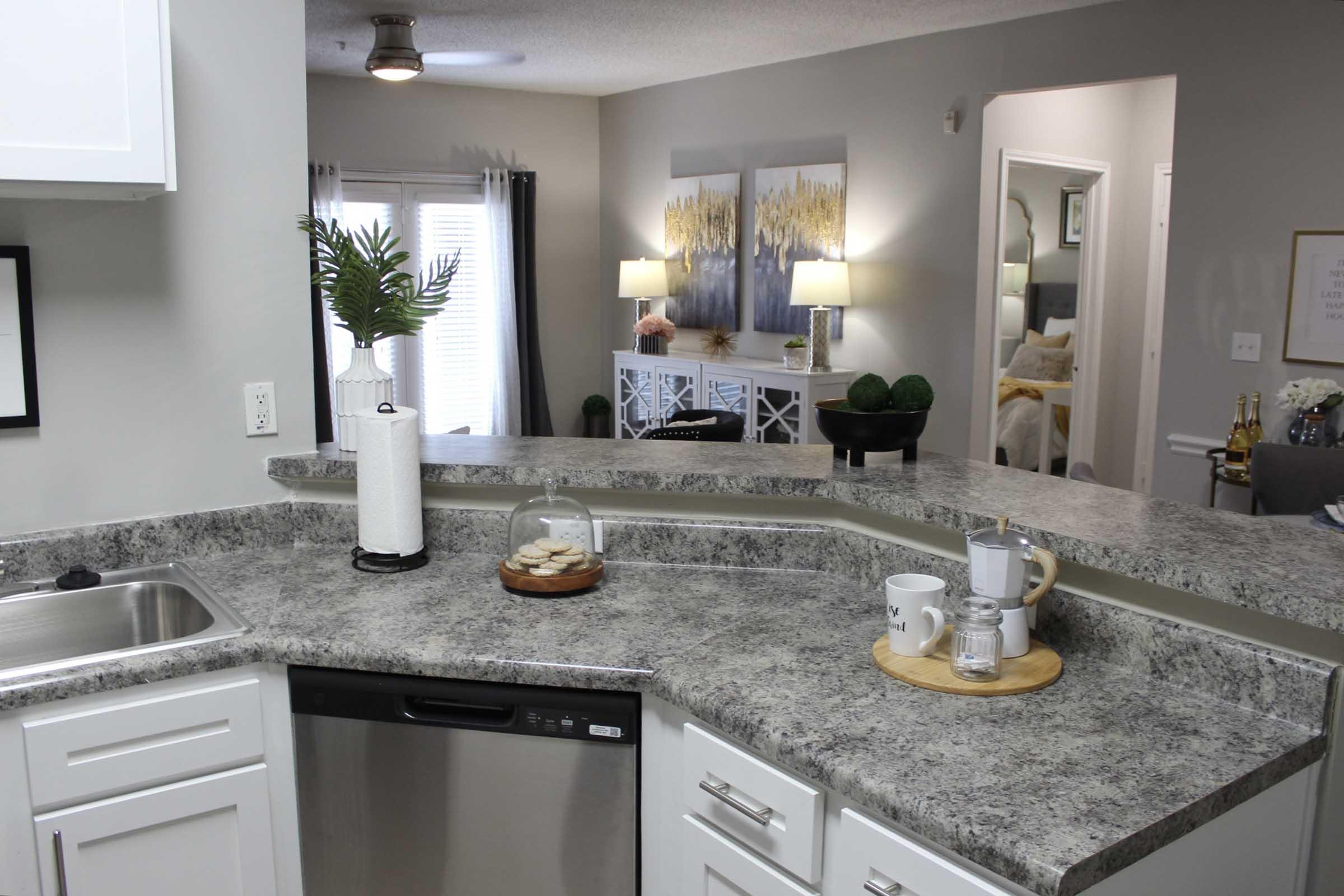 a kitchen with a sink and a mirror