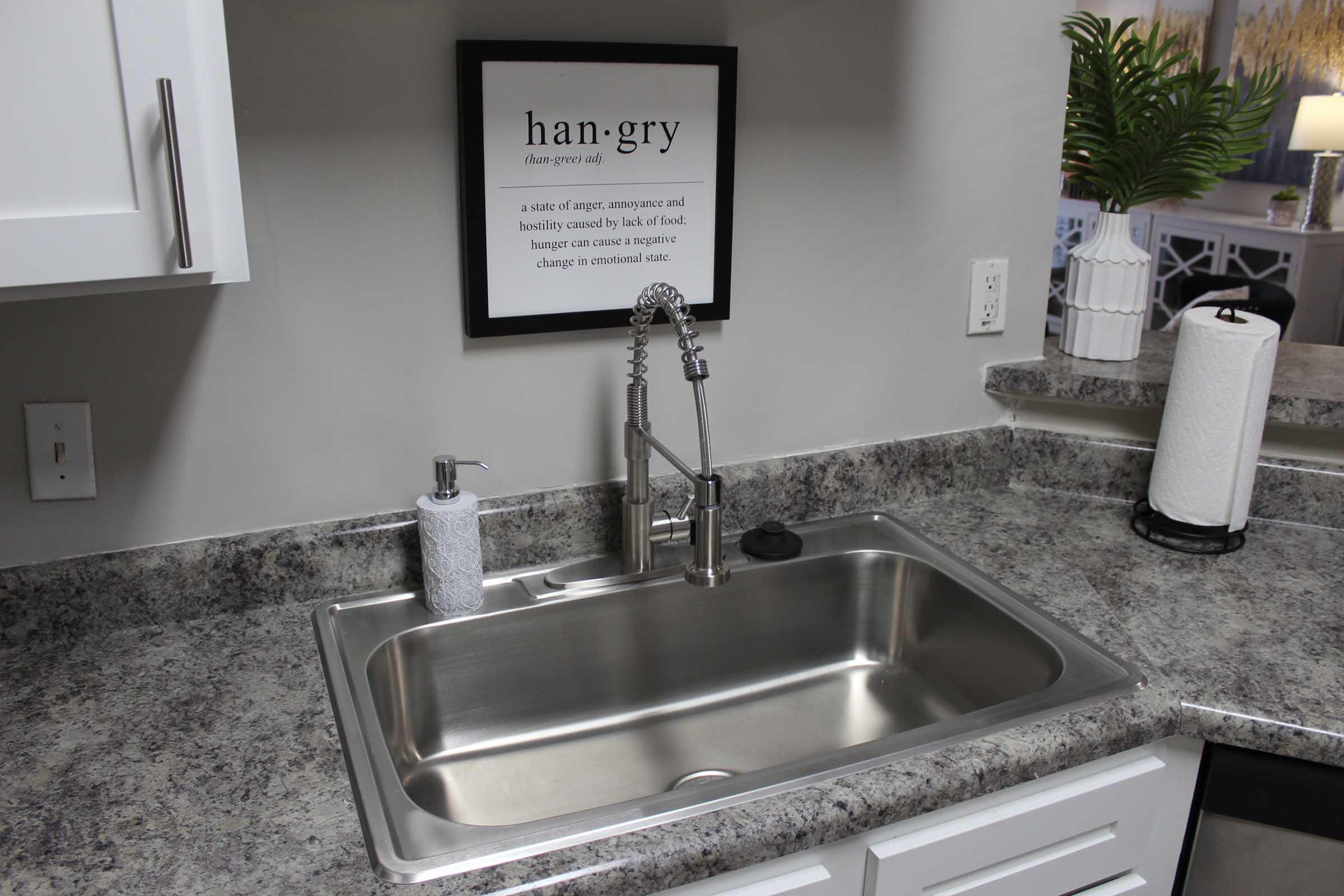 a kitchen with a sink and a mirror