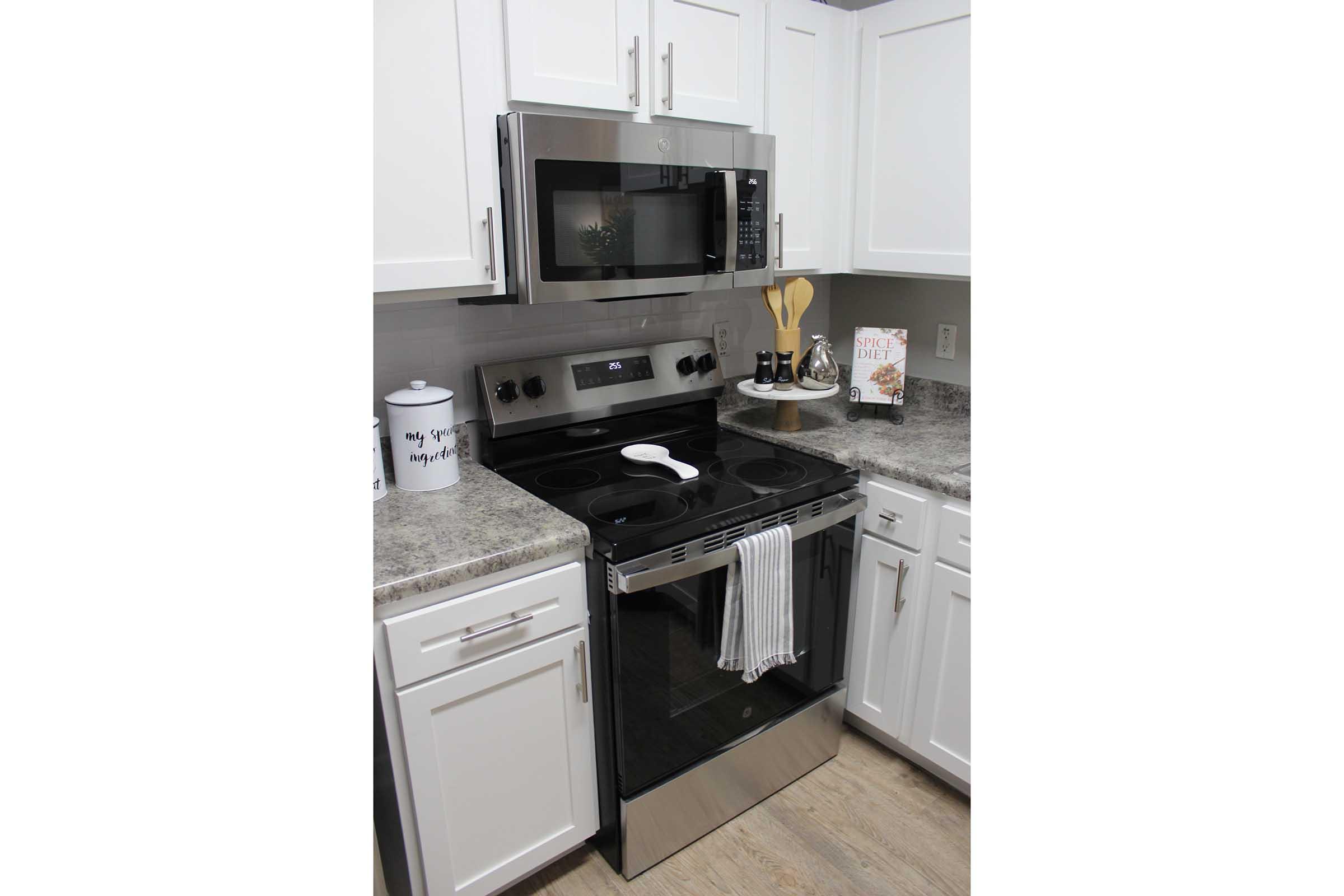 a stove top oven sitting inside of a kitchen