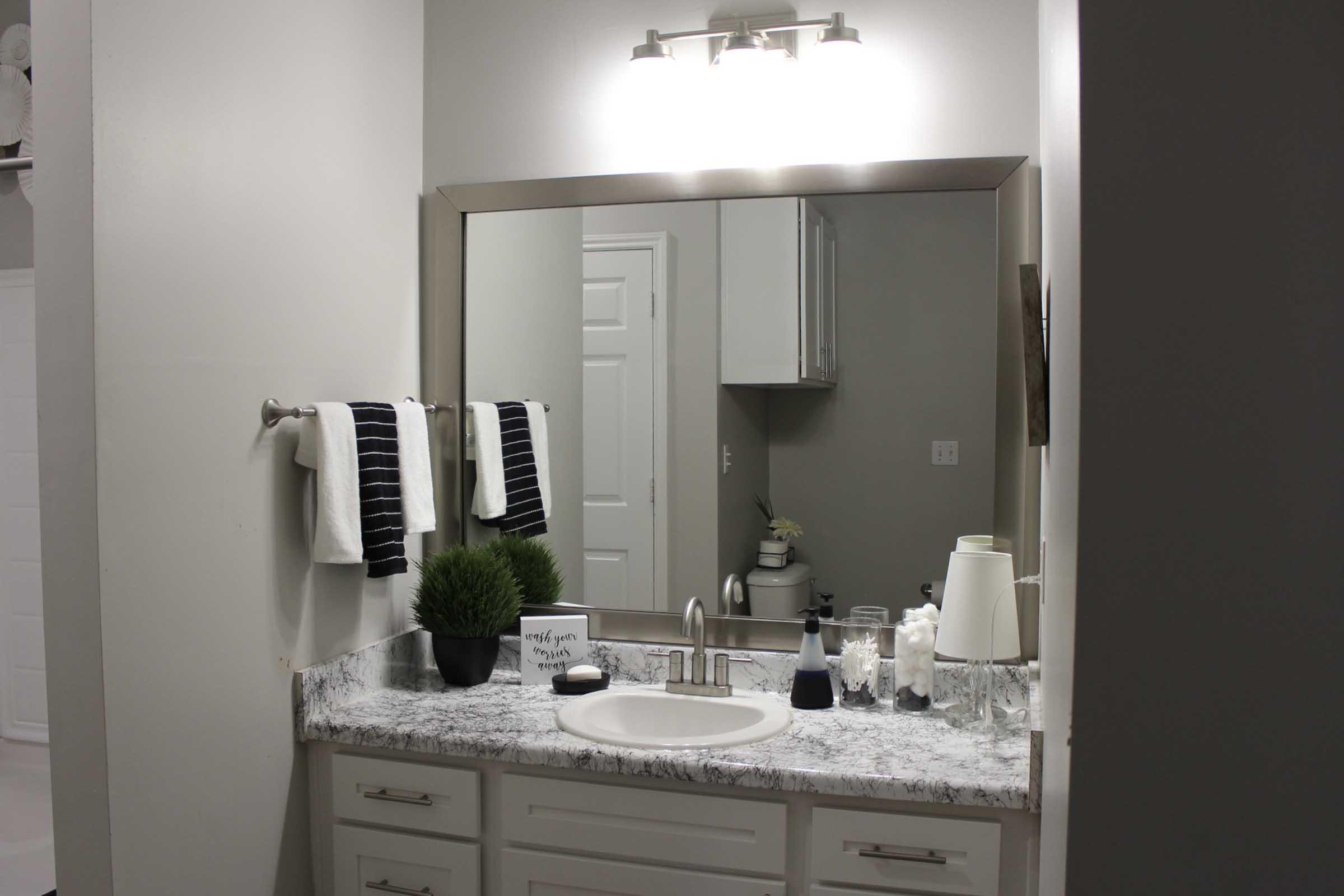 a kitchen with a sink and a mirror