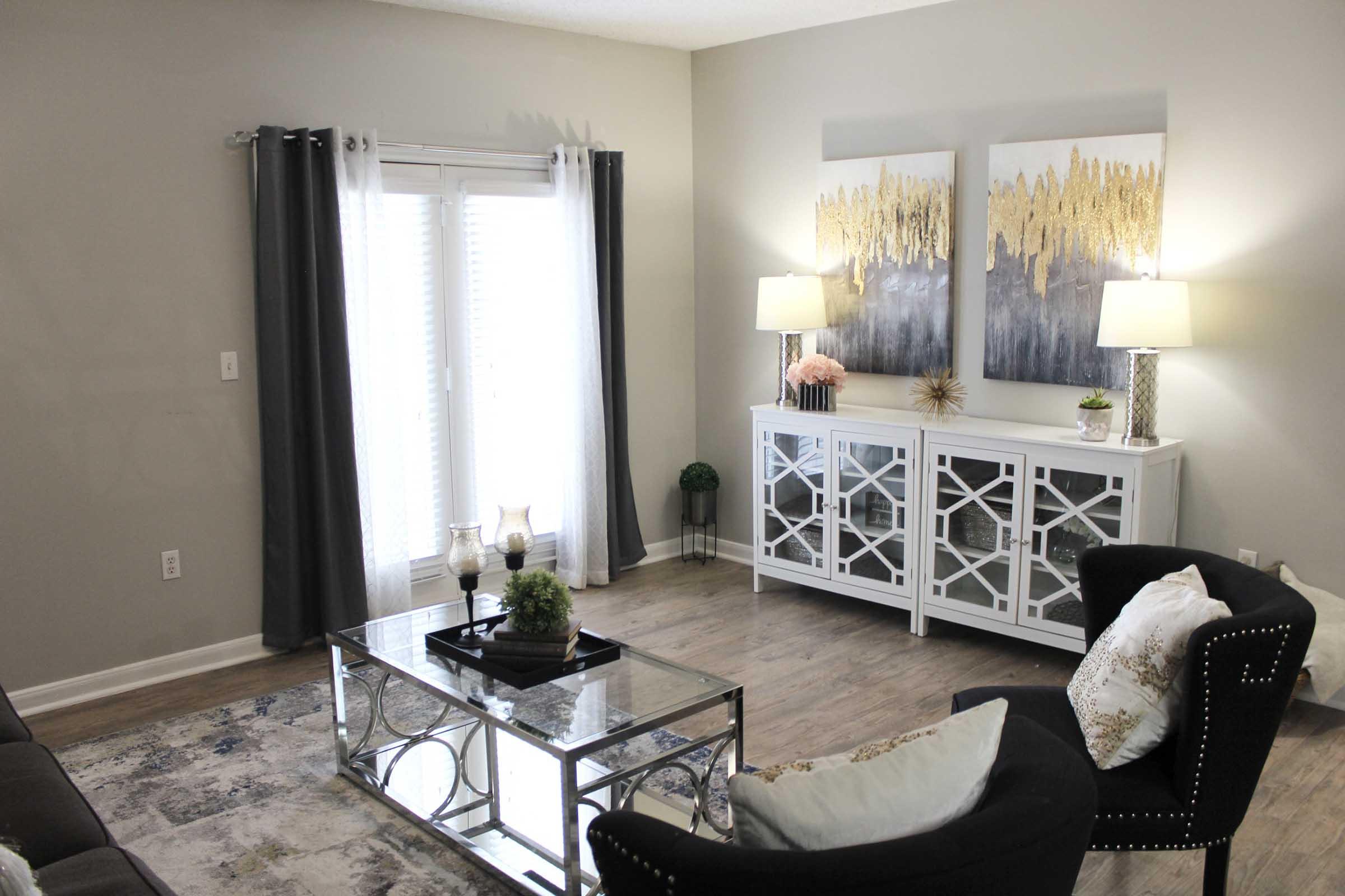 a living room filled with furniture and a mirror