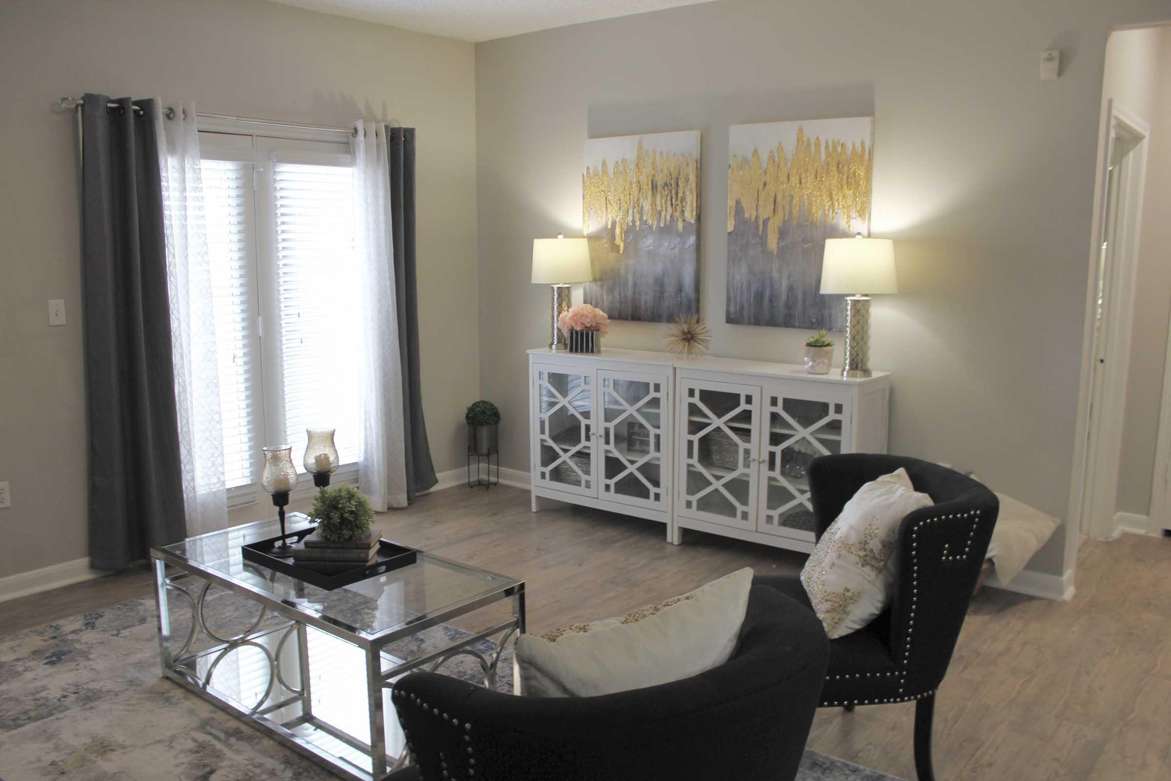 a living room filled with furniture and a mirror