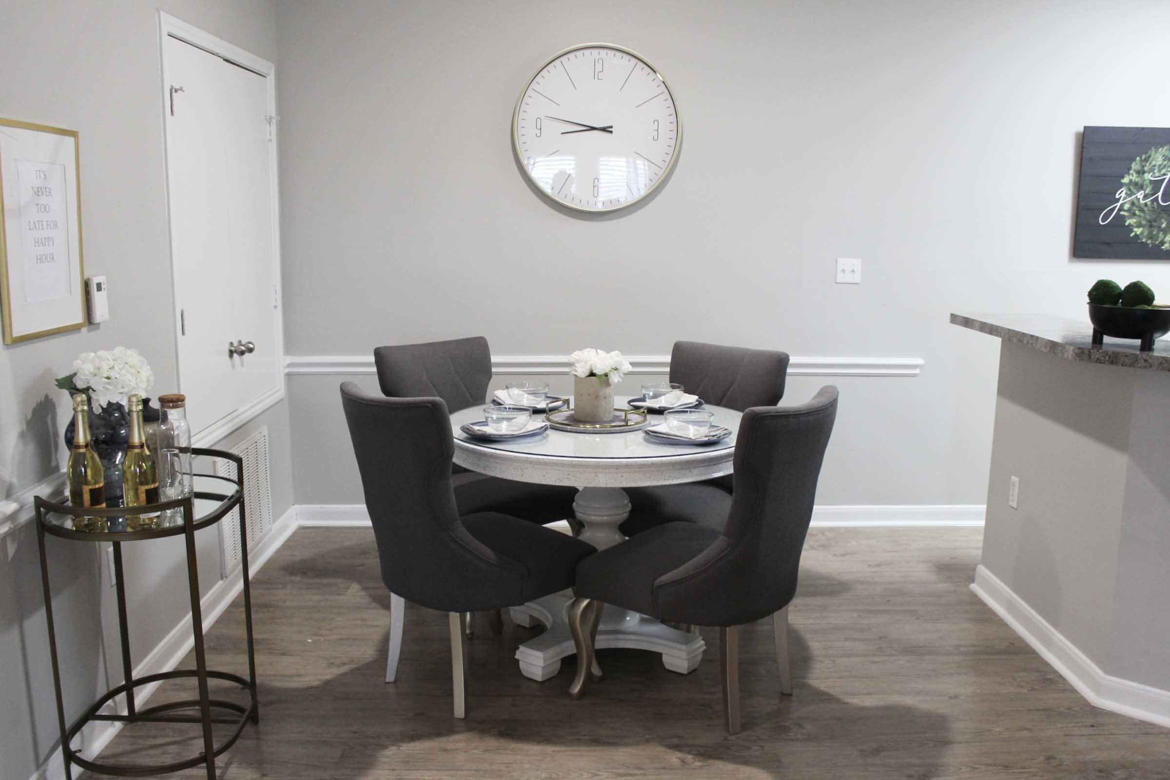 a living room with a clock on a table