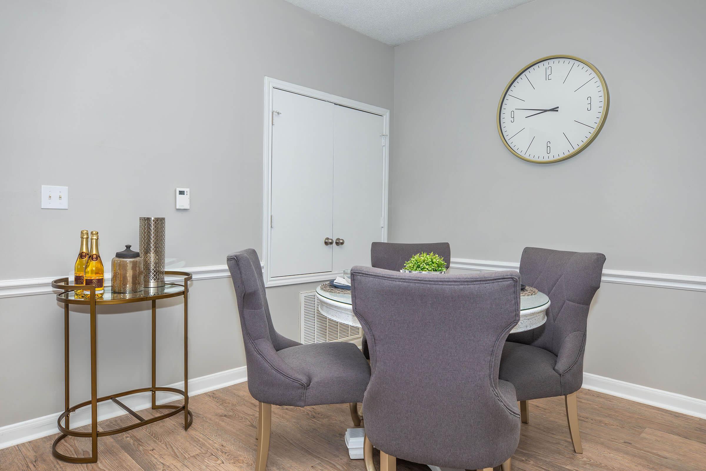 a living room with a clock on a table