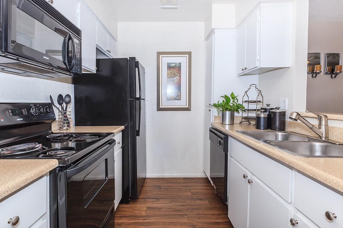 a kitchen with a stove and a sink