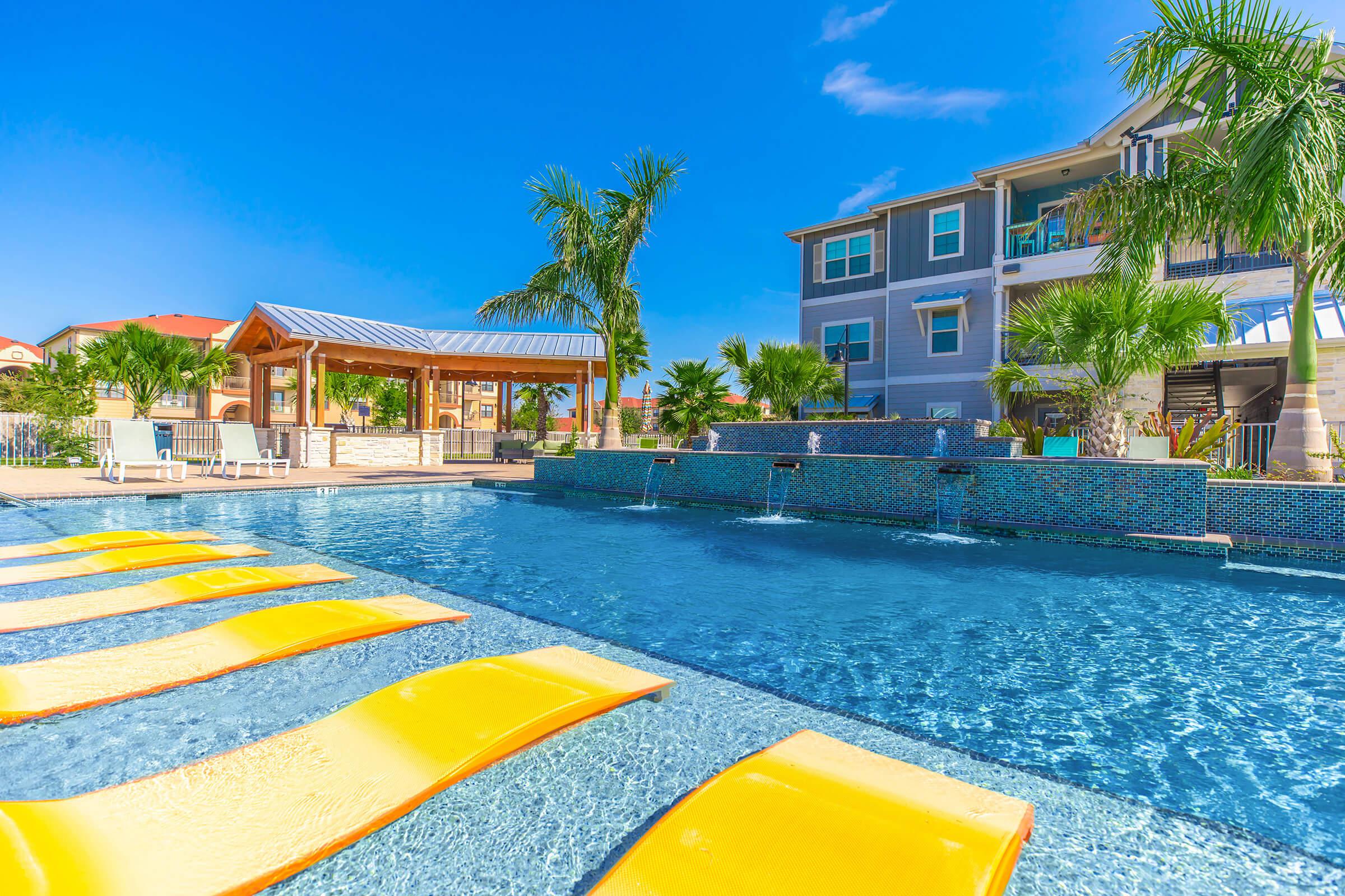 a yellow umbrella in a pool of water