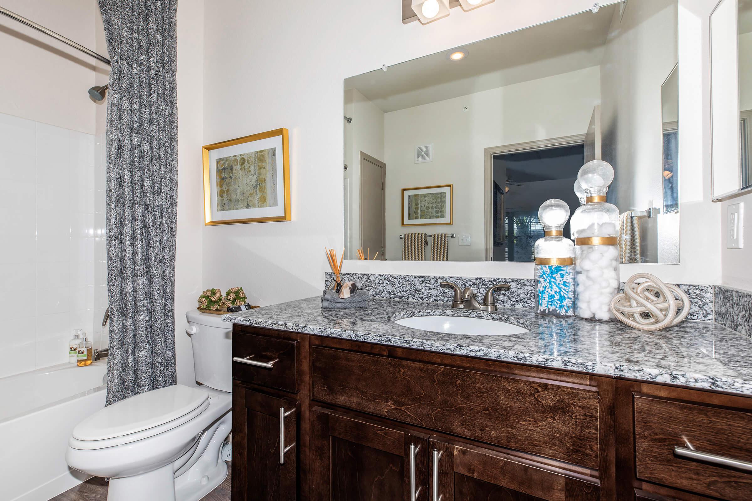 a kitchen with a sink and a mirror