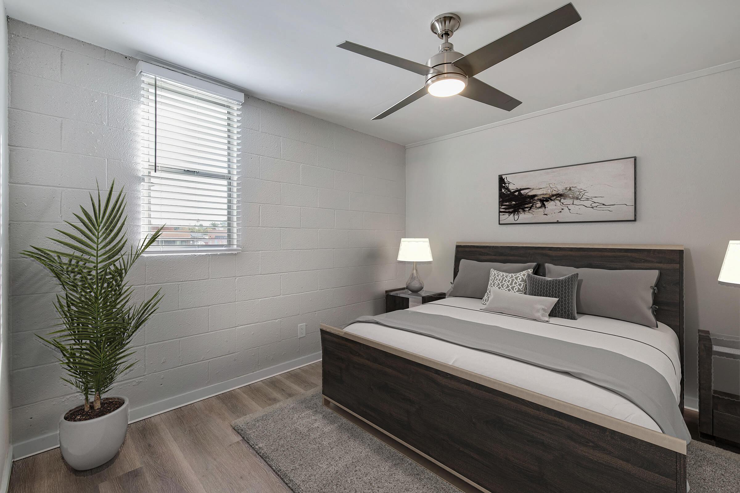 a bedroom with a bed and desk in a room