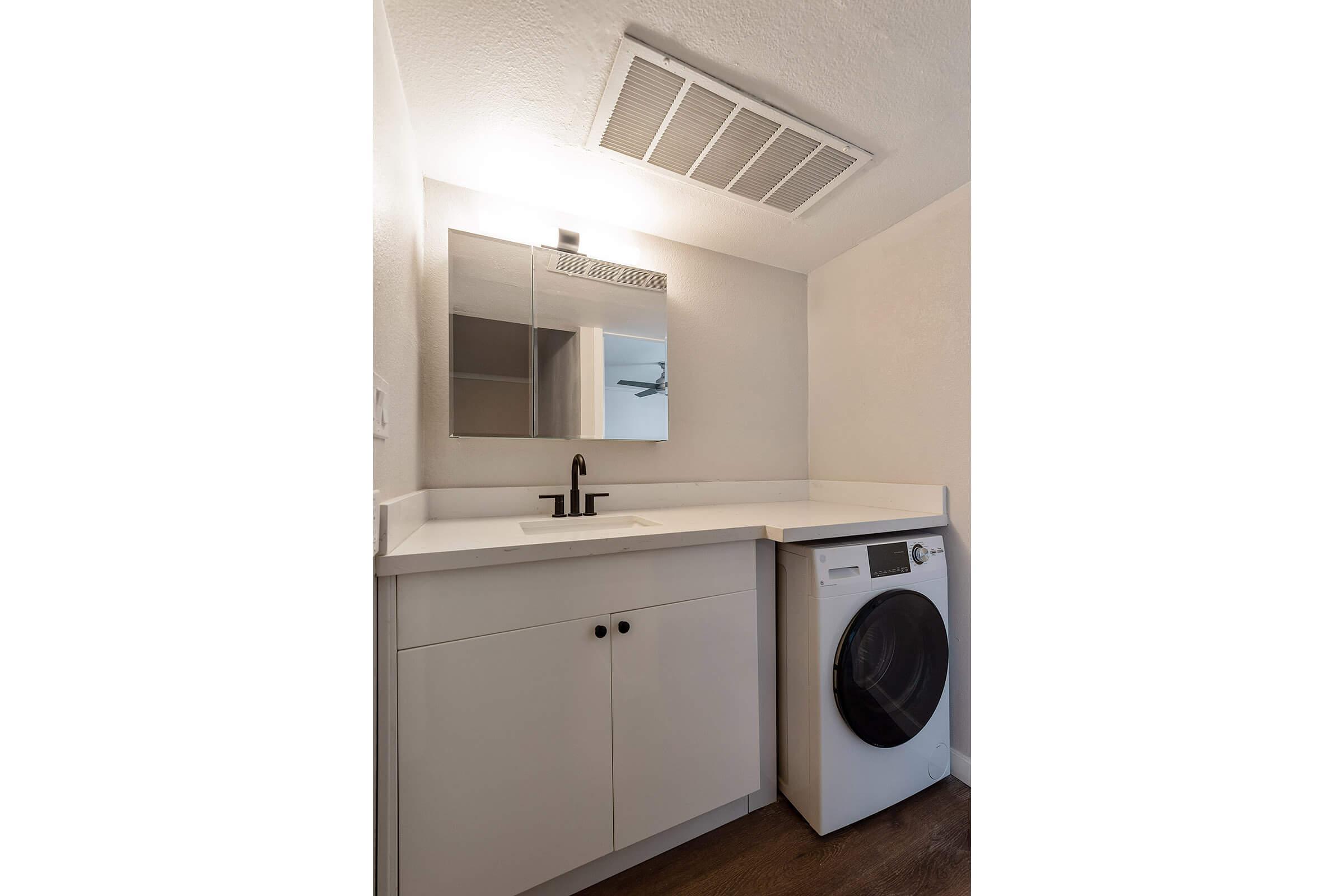 a kitchen with a sink and a microwave