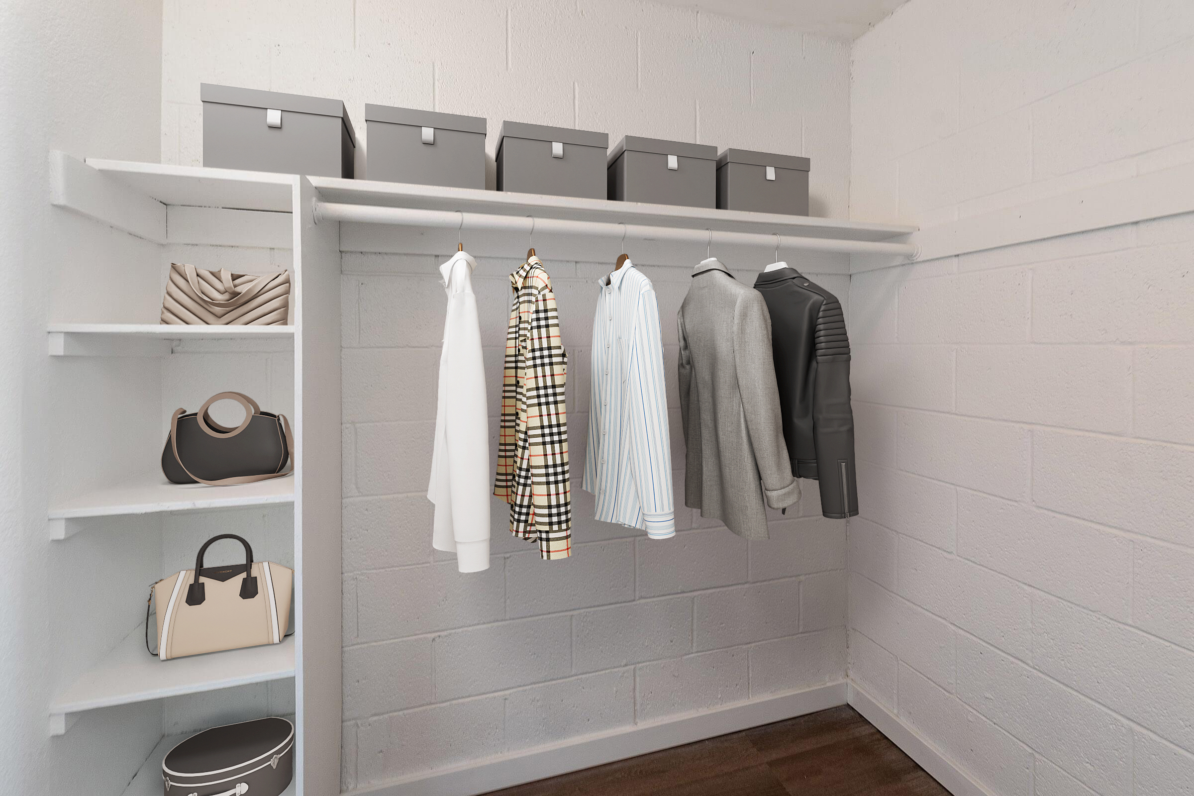 A neatly organized closet featuring hanging clothing items, including shirts and jackets, along with several gray storage boxes on the shelf above. The left side displays a shelf with stylish handbags. The closet has a clean, minimalist aesthetic with white walls and a dark floor.