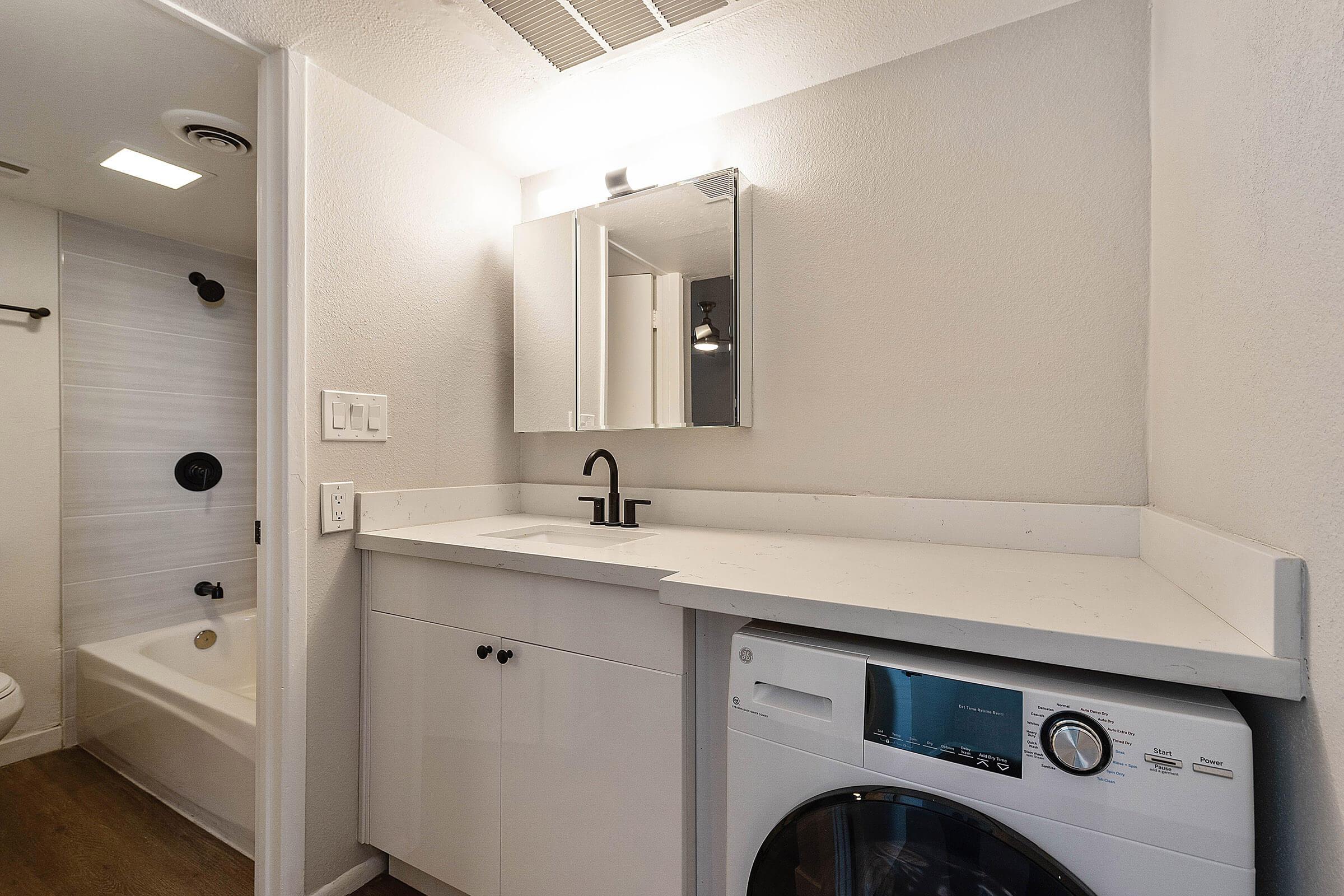 a kitchen with a sink and a mirror