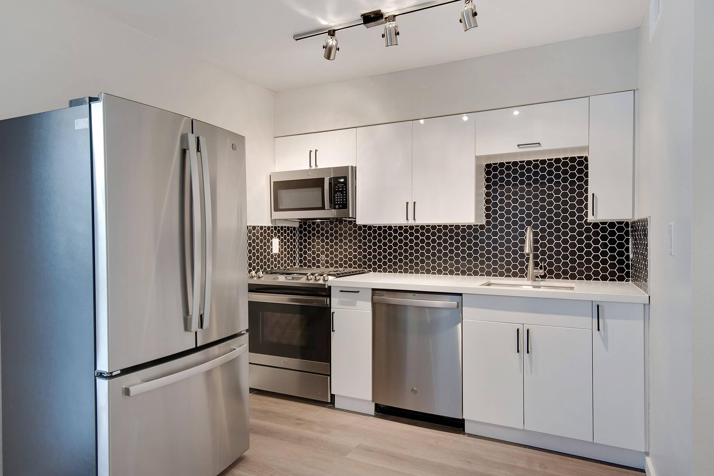 a kitchen with a stove and a refrigerator